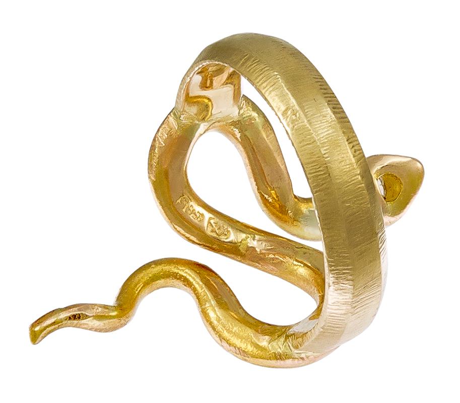 Unique and most appealing ring:  a large sinuous figural snake that wraps around the front of the finger.   Set in 14K satin finish yellow gold.  The head is set with a .25 ct. old mine cut diamond; the eyes are cabochon emeralds.  Size 6 1/2 and