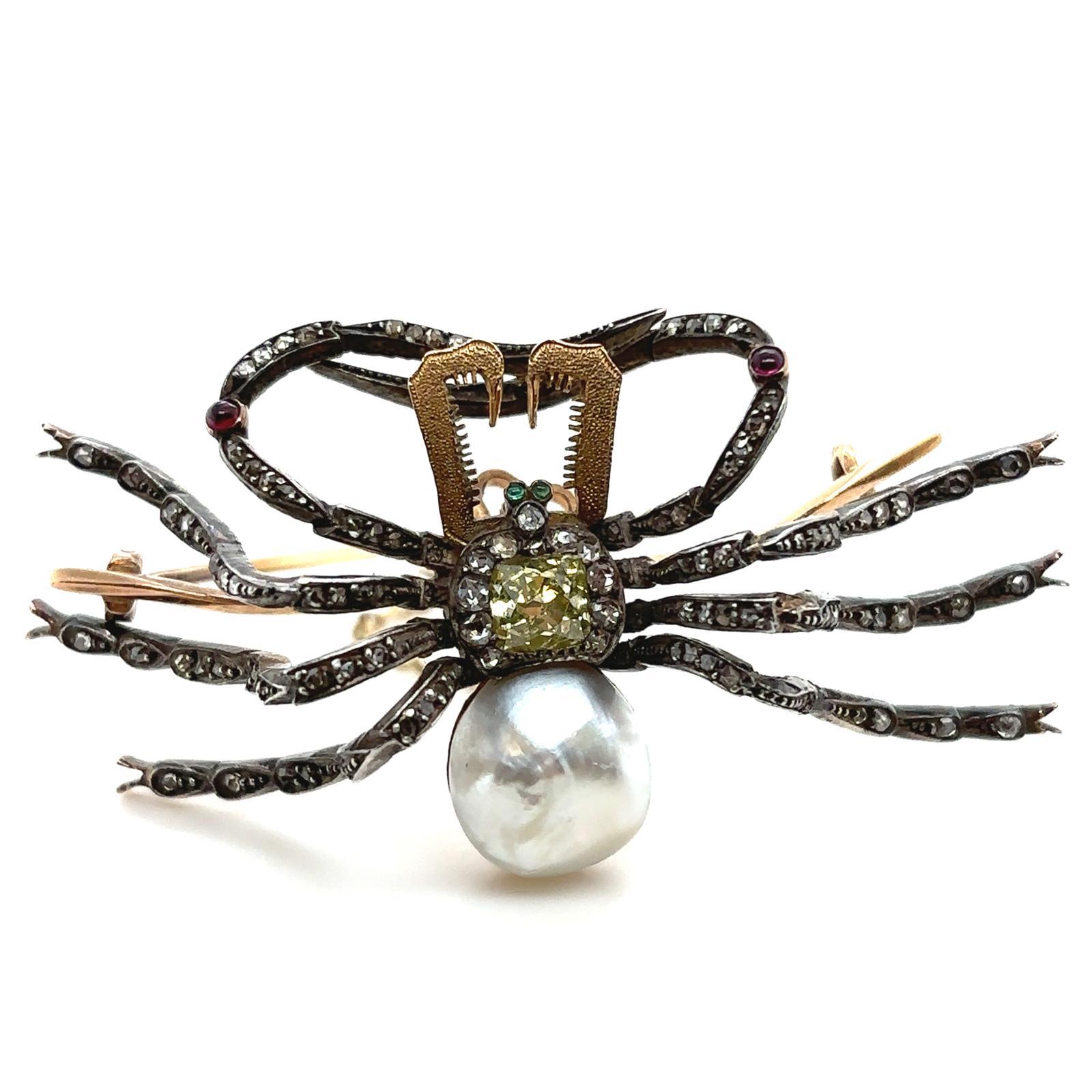 An antique diamond, emerald, ruby and baroque pearl spider brooch pin in 18 karat yellow gold and silver, circa 1890.

A perfect addition to any black jacket this beautiful and unusual realistically modelled brooch is in the form of a large spider.