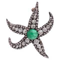 Antica spilla a forma di stella marina in argento e oro con diamante e smeraldo
