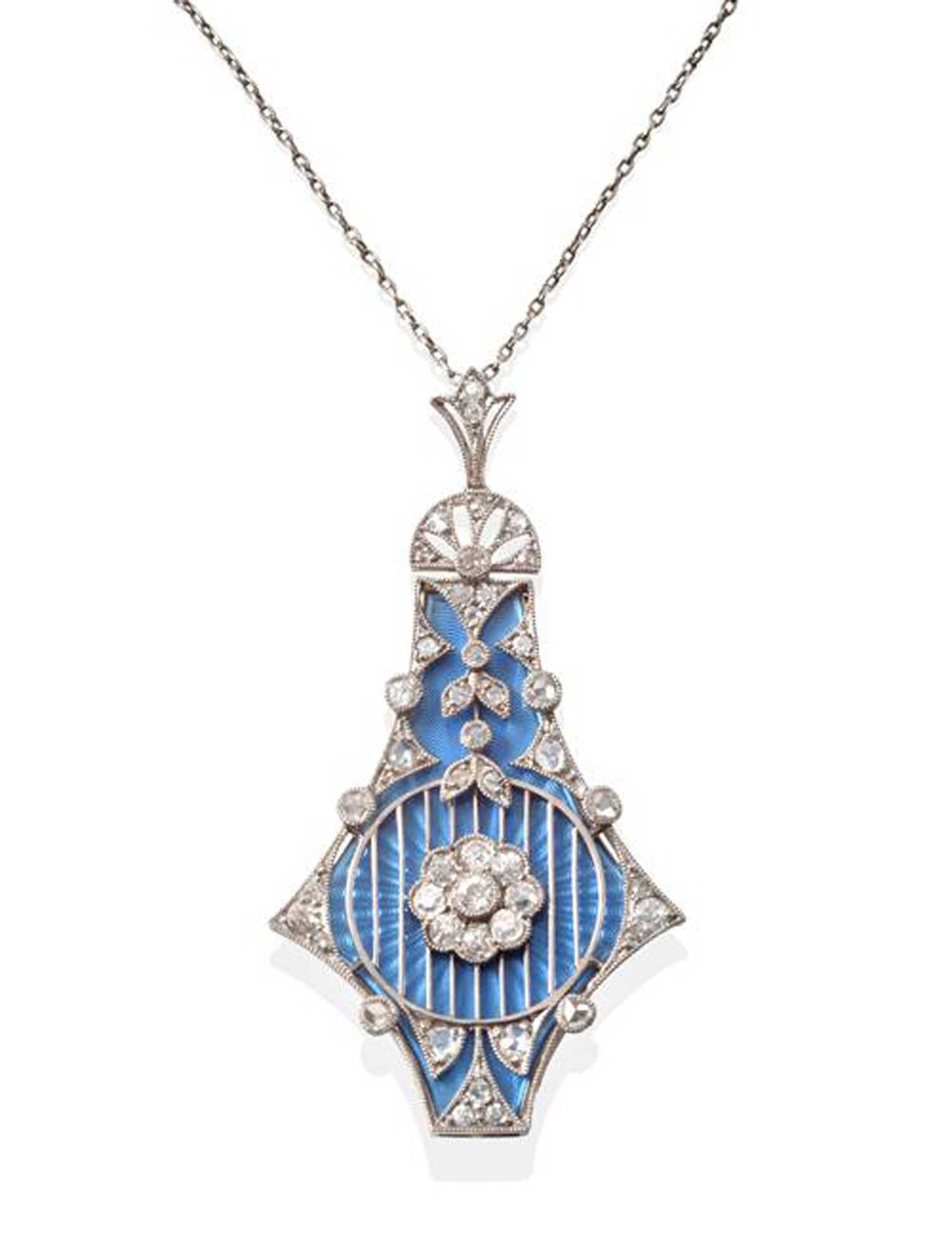 An antique diamond and enamel pendant in the Belle Epoque style with three interchangeable guilloche enamel plaques, one each in pink, pale blue, and mid-blue.  The pendant outline is in the form of an abstract kite-shape pendant measuring 1.96