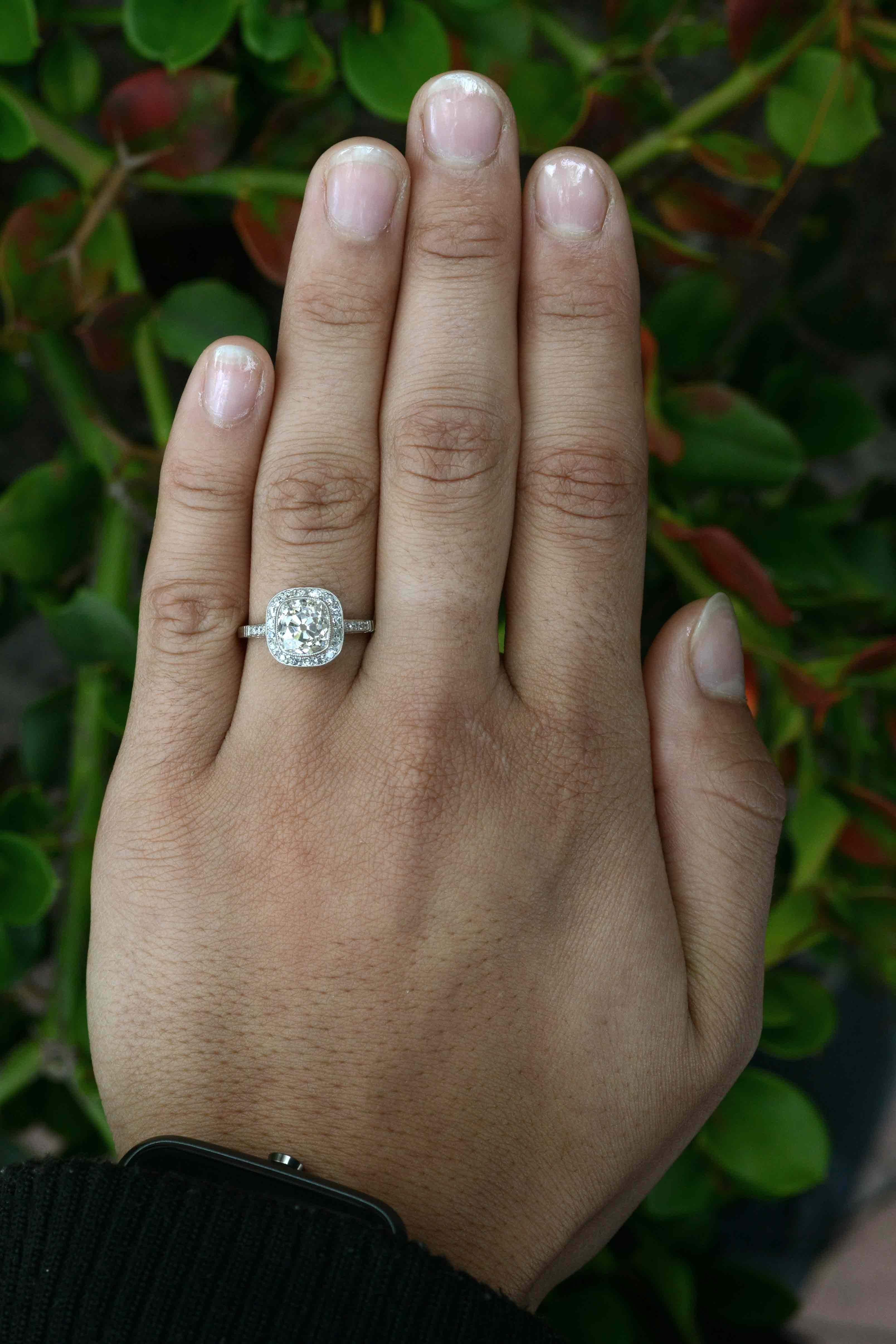 A large-and-in-charge antique diamond engagement ring centered by a most captivating old mine cut diamond cushion cut chunk weighing an impressive 2.23 carats. We hand made the Art Deco platinum masterpiece from the ground up, using a well loved,