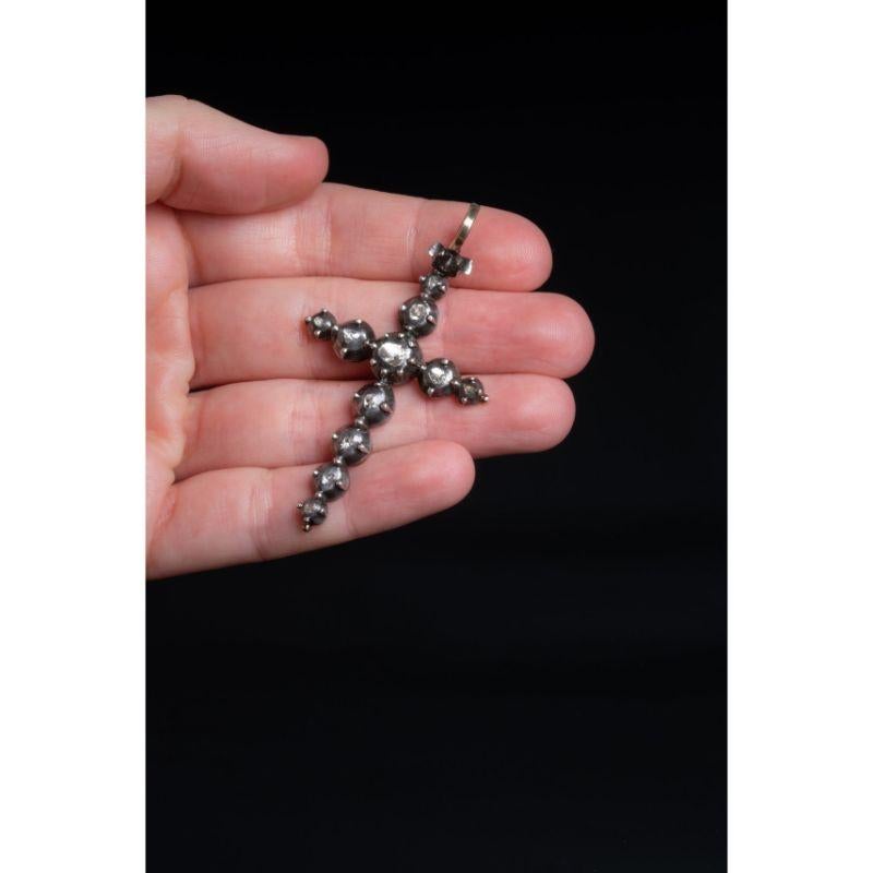 A large silver cross pendant set with 11 old cut diamonds. Made of solid silver and dating back to the early 1900's this cross is a revival of late Georgian diamond crosses.

The pendant is set with 11 old cut diamonds, which catch both day and