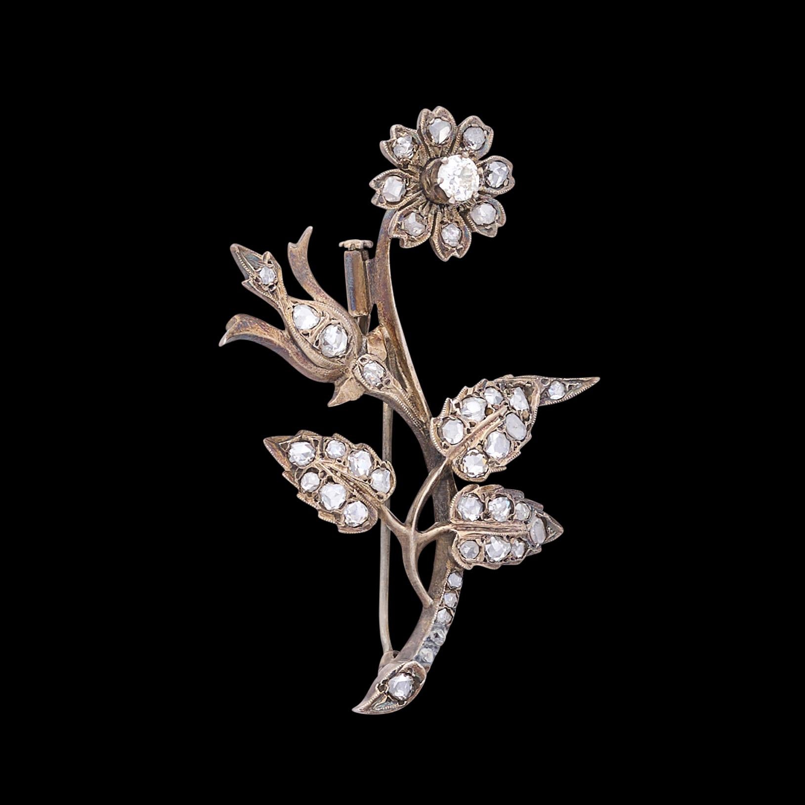 From the Victorian era, this charming French silver brooch is set with numerous rose and table-cut diamonds, with one European-cut diamond highlight, weighing in total an estimated 1.50 carats. The brooch measures 2 3/4 x 1 5/9 inches, and weighs