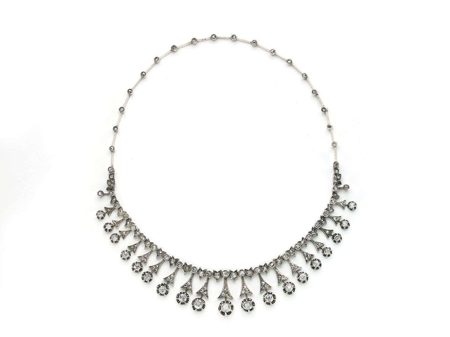An antique diamond tiara / necklace, set with old-cut and rose-cut diamonds, with a row of alternating old-cut diamonds, in rub over settings and old-cut diamonds in grain set chevrons. The rub over set diamonds surmount fan shaped mounts, each set
