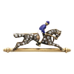 Broche ancienne cheval et jockey en or jaune, grenat, émail et diamants