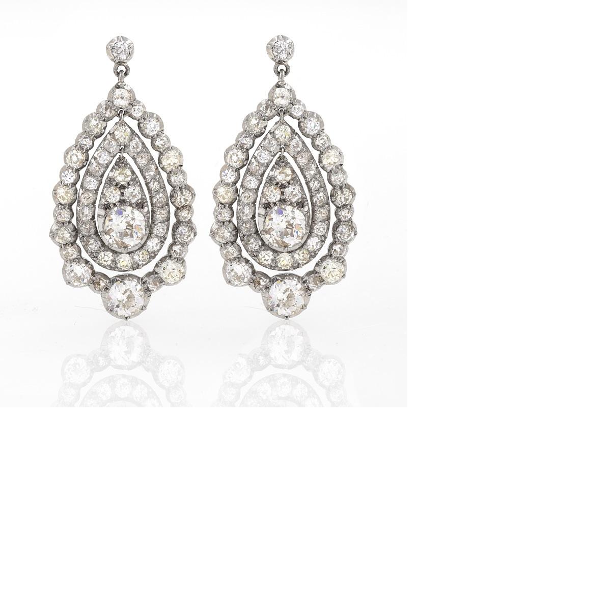 A pair of antique silver-top/18 karat gold rhodium plated earrings with diamonds. The earrings have 96 Old European-cut diamonds with an approximate total weight of 8.70 carats, (including large diamonds, approximate weight .75 carat each), H/I/J