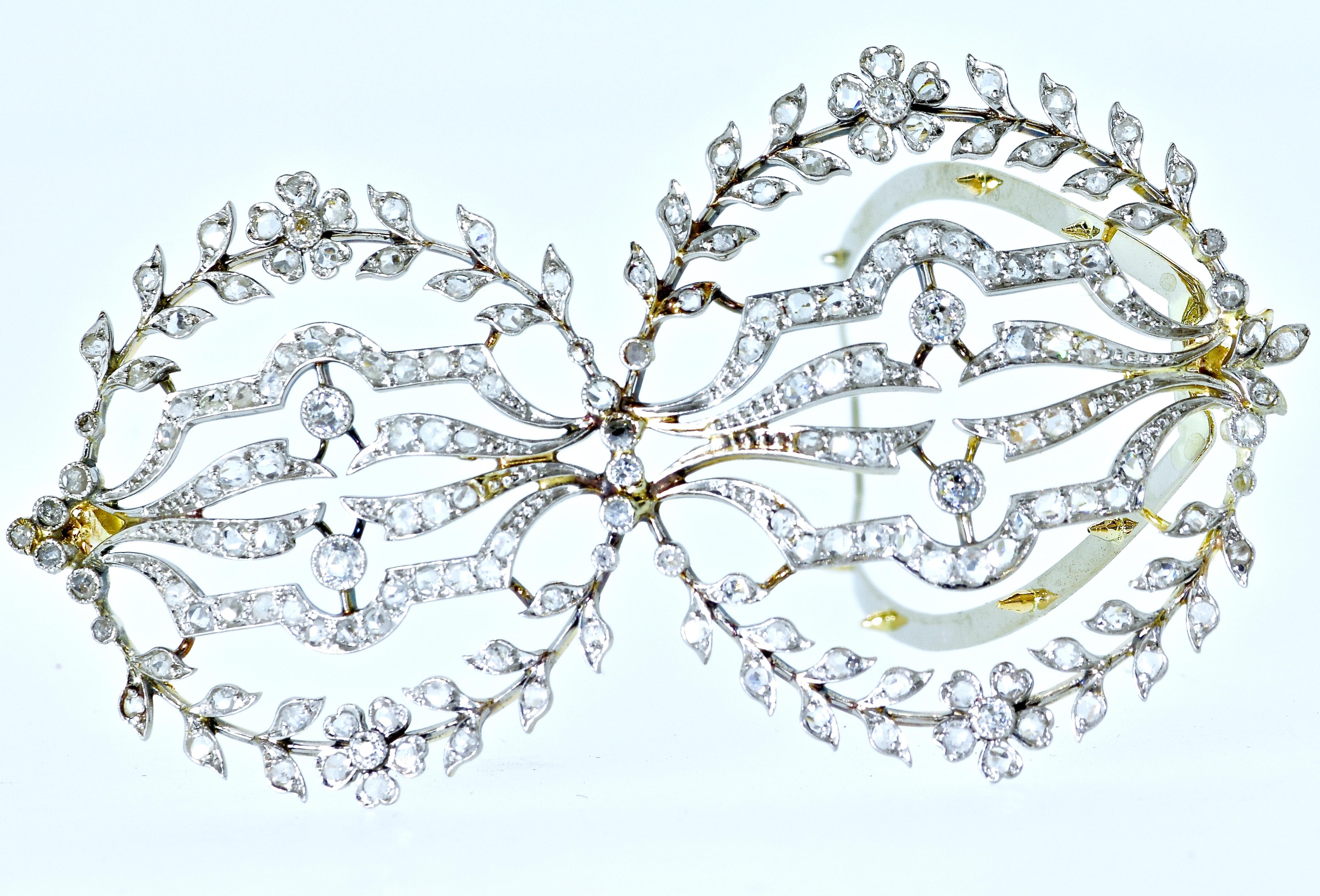 Antique diamond hair barrette with both rose cut and mine cut diamonds set in platinum and backed with yellow gold.  This Edwardian barrette is 3 inches in length with an unusual asymmetrical floral design.  Delicate and unusual, this distinctive