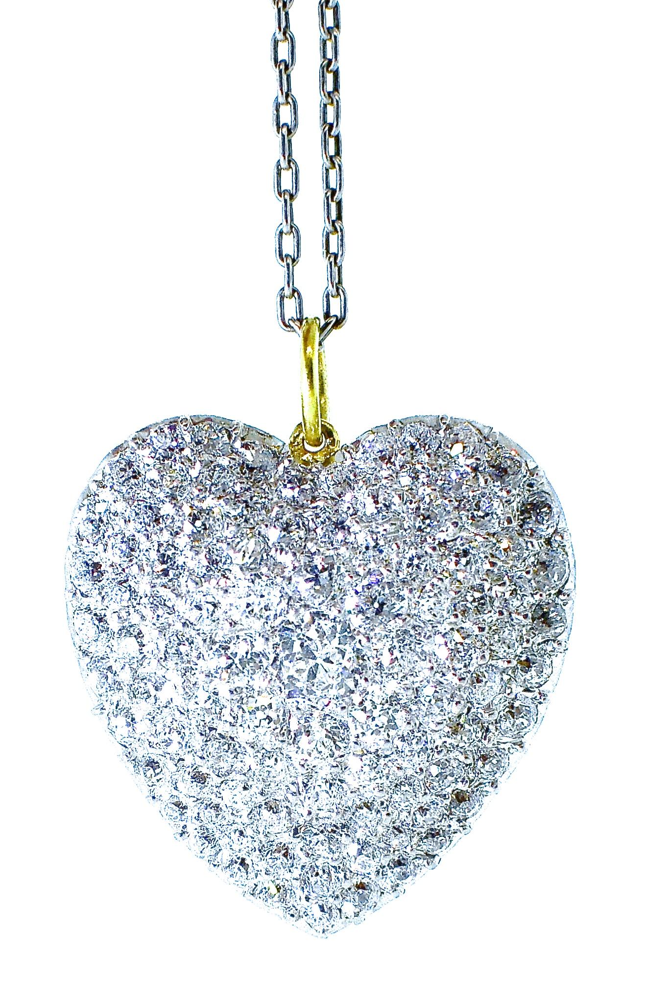 Antique diamond heart pendant in platinum and 18K gold.  Approximately 3 cts., of fine white diamonds, all well cut and well matched, H in color (near colorless) and very slightly included (VS) in clarity.  Pave set in platinum.  Note how well the