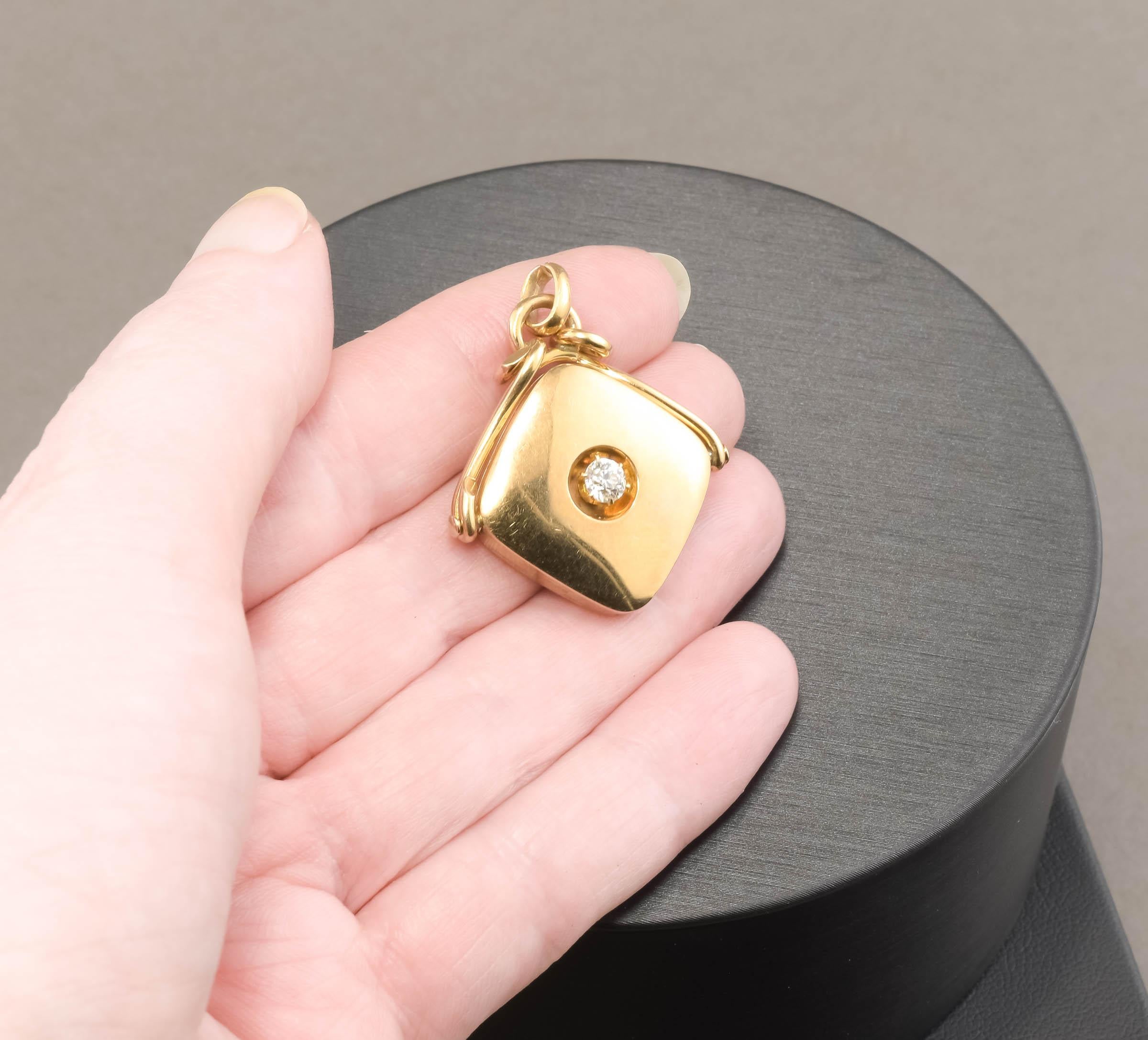 Offered is a lovely antique, late Victorian 14K gold locket fob pendant set with a brilliant and fiery Old European cut diamond estimated at .32 carats.  (please note that there are a lot of dark reflections on the gold in my photos - it was very