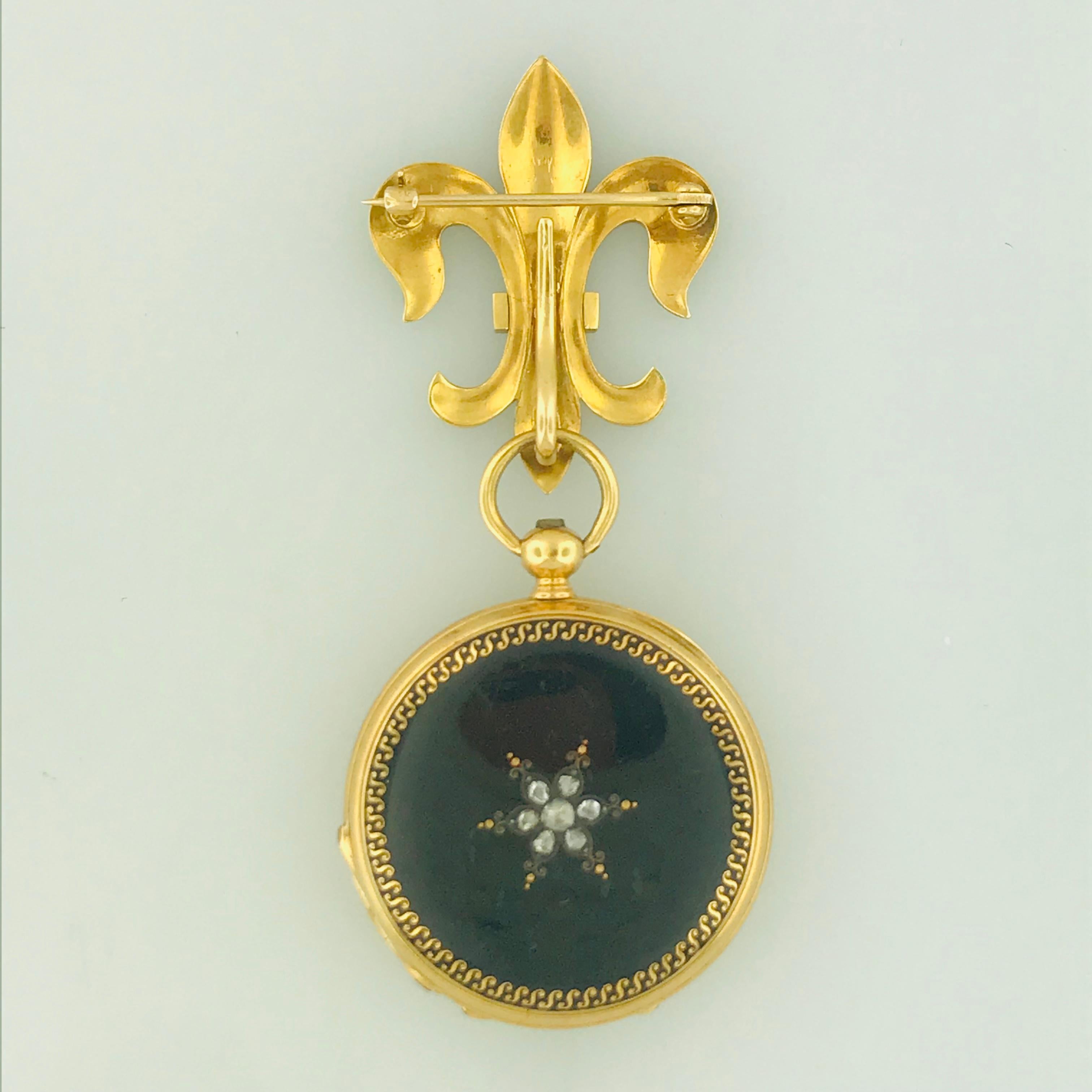 This extremely unique French watch pin has an 18 karat yellow gold, black enamel diamond fluer de lis pin and a matching black enamel diamond 
