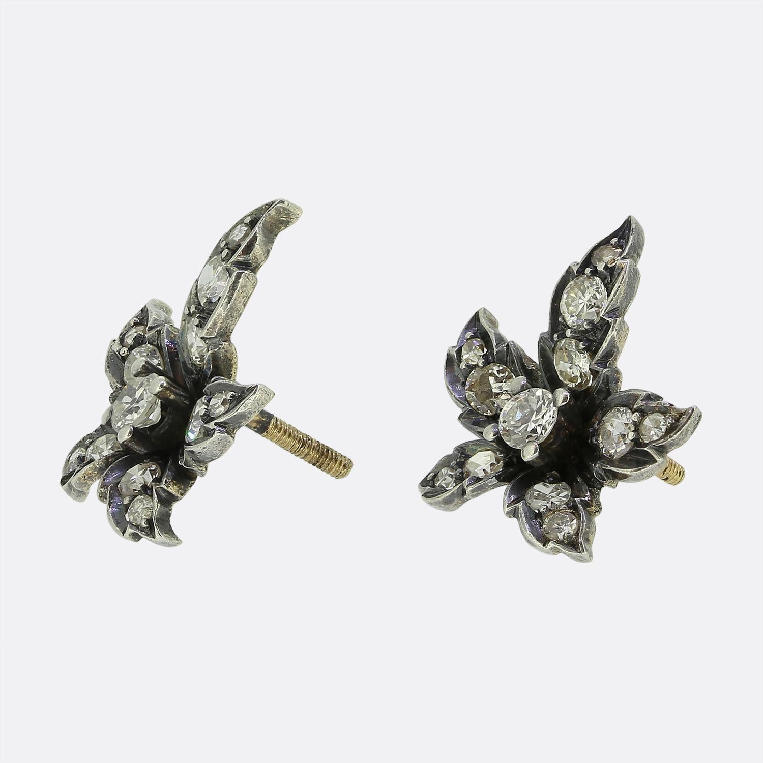 Here we have a gorgeous pair of Victorian diamond cluster earrings. Each identical antique piece has been crafted from a blend of 18ct yellow gold and silver into the shape of five leaflet leaf similar to those found on a maple tree. The intricate