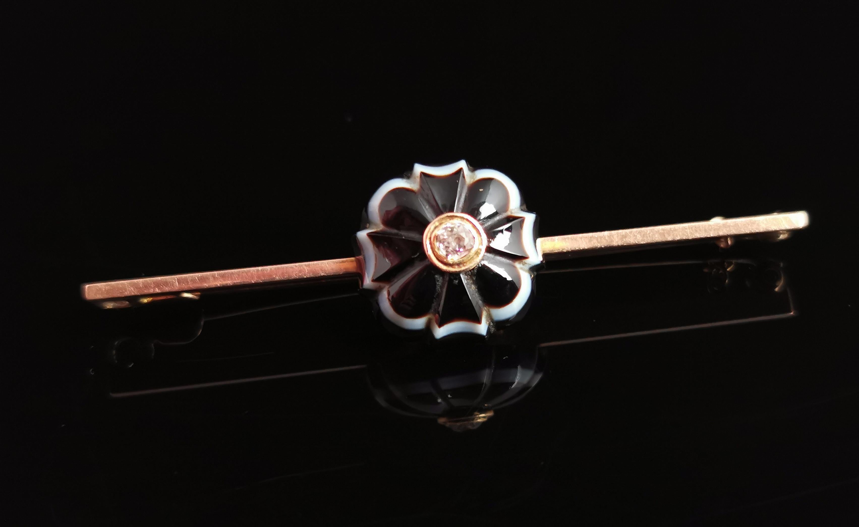 A beautiful antique Diamond and banded agate mourning brooch.

This is a tremendously beautiful piece, an antique gold bar brooch with a very well carved banded agate flower.

The forget me not flower has beautiful rich tones, mostly in black with