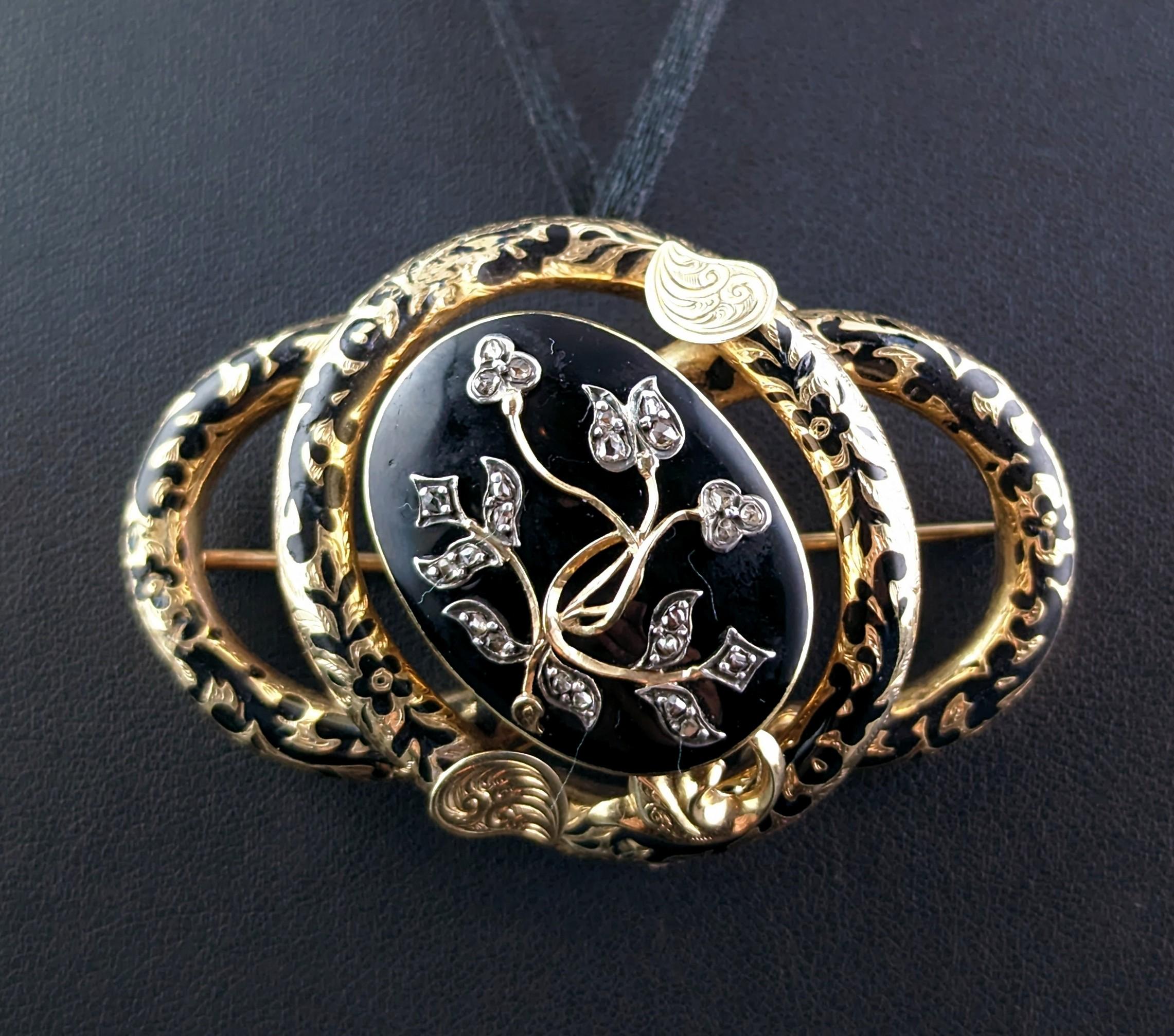 This is truly one of the most spectacular and beautiful antique mourning brooches of its design.

It is a very large sized brooch and can also be worn as a pendant, it is a knot form with engraved tendrils forming the knot shape, encompassing a