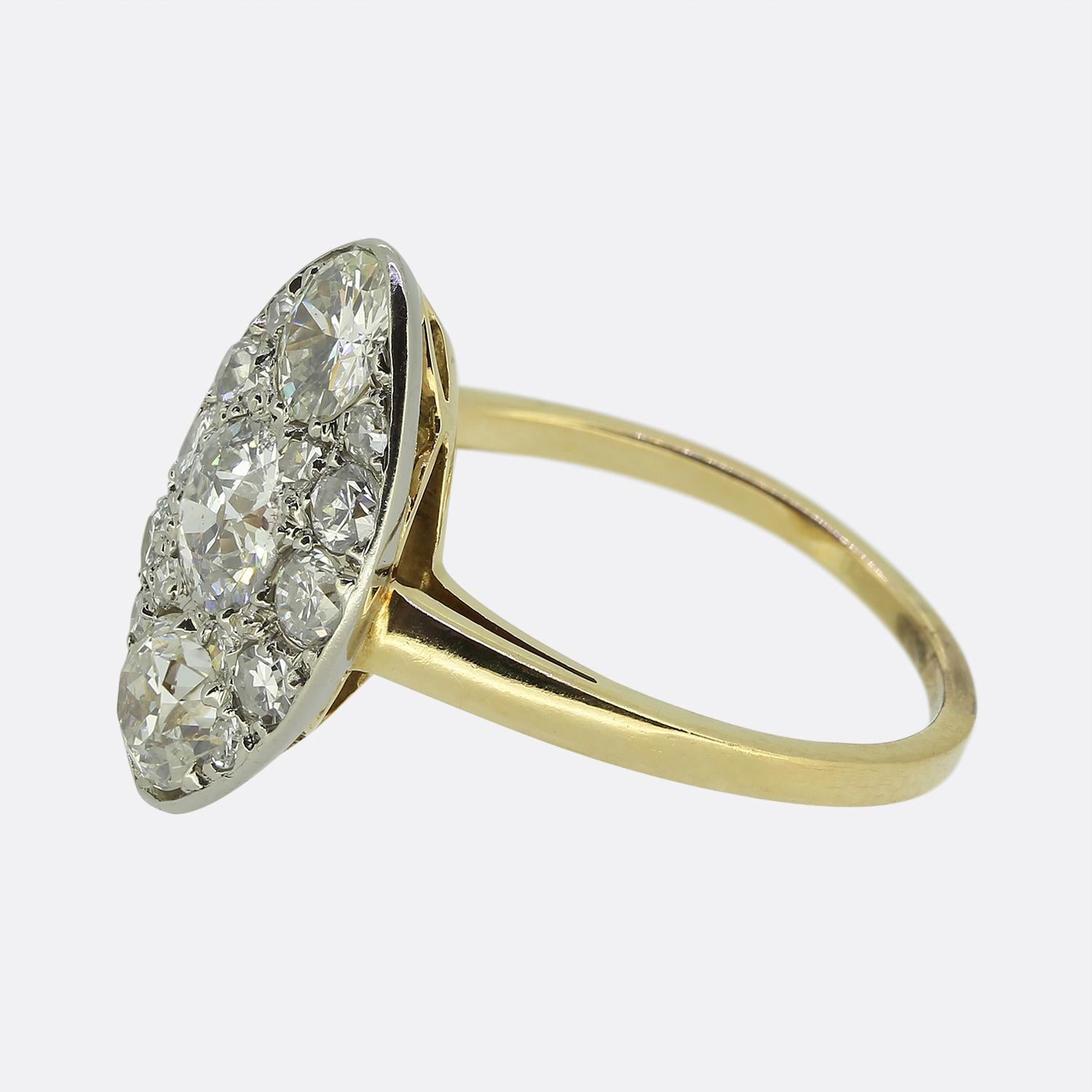 Here we have a classically styled navette ring taken from the Edwardian period. This antique piece features a stunning array of round faceted old cut diamonds collectively resulting in a bright white radiant display. Each stone has been individually