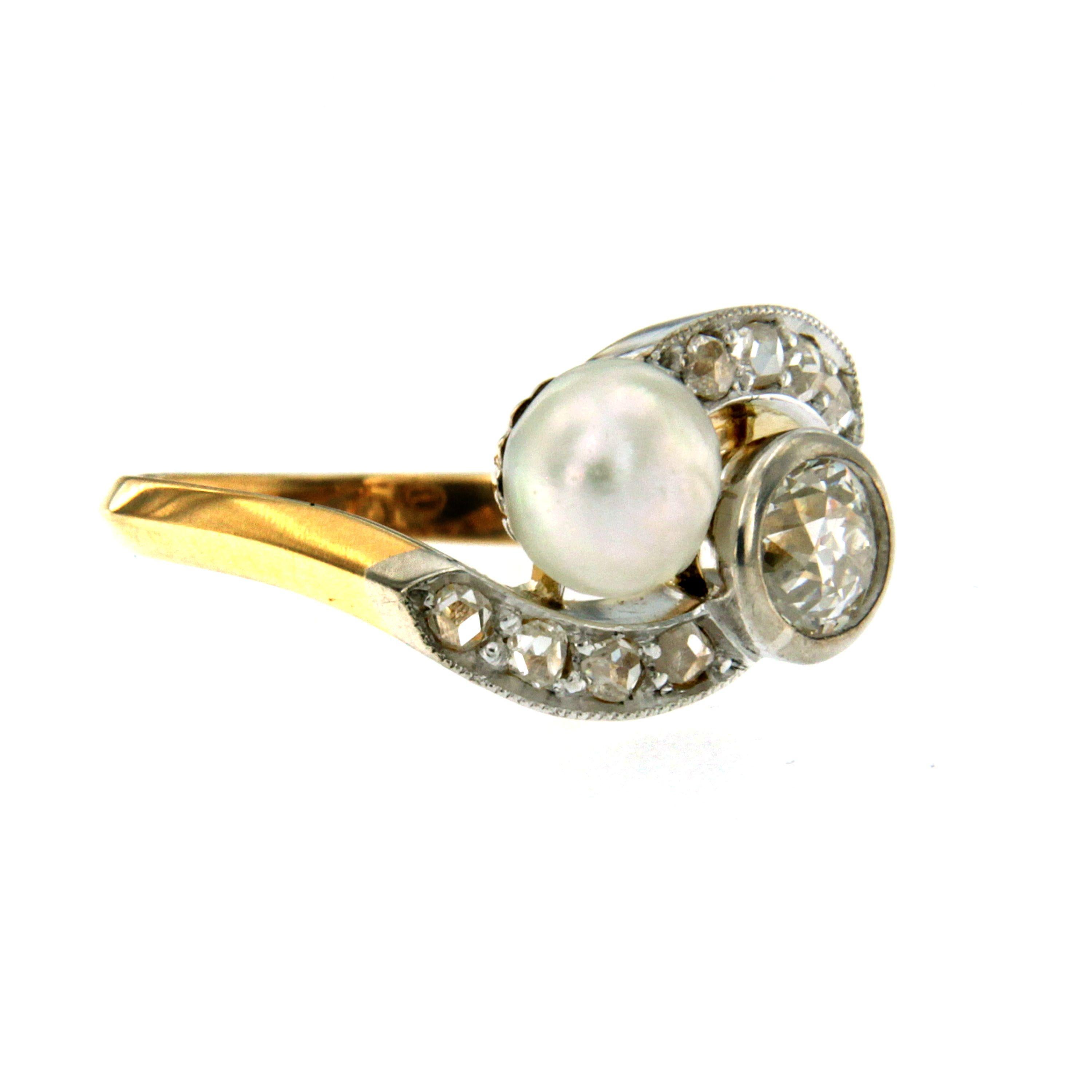 A beautiful 18k gold 'Vous et Moi' ring set with an old mine cut diamond weighing 0.40 carat I color VS2 clarity and a natural pearl, surrounded by 0.15ct old mine diamond. Late 1800

CONDITION: Pre-owned - Excellent 
METAL: 18k Gold 
GEM STONE: