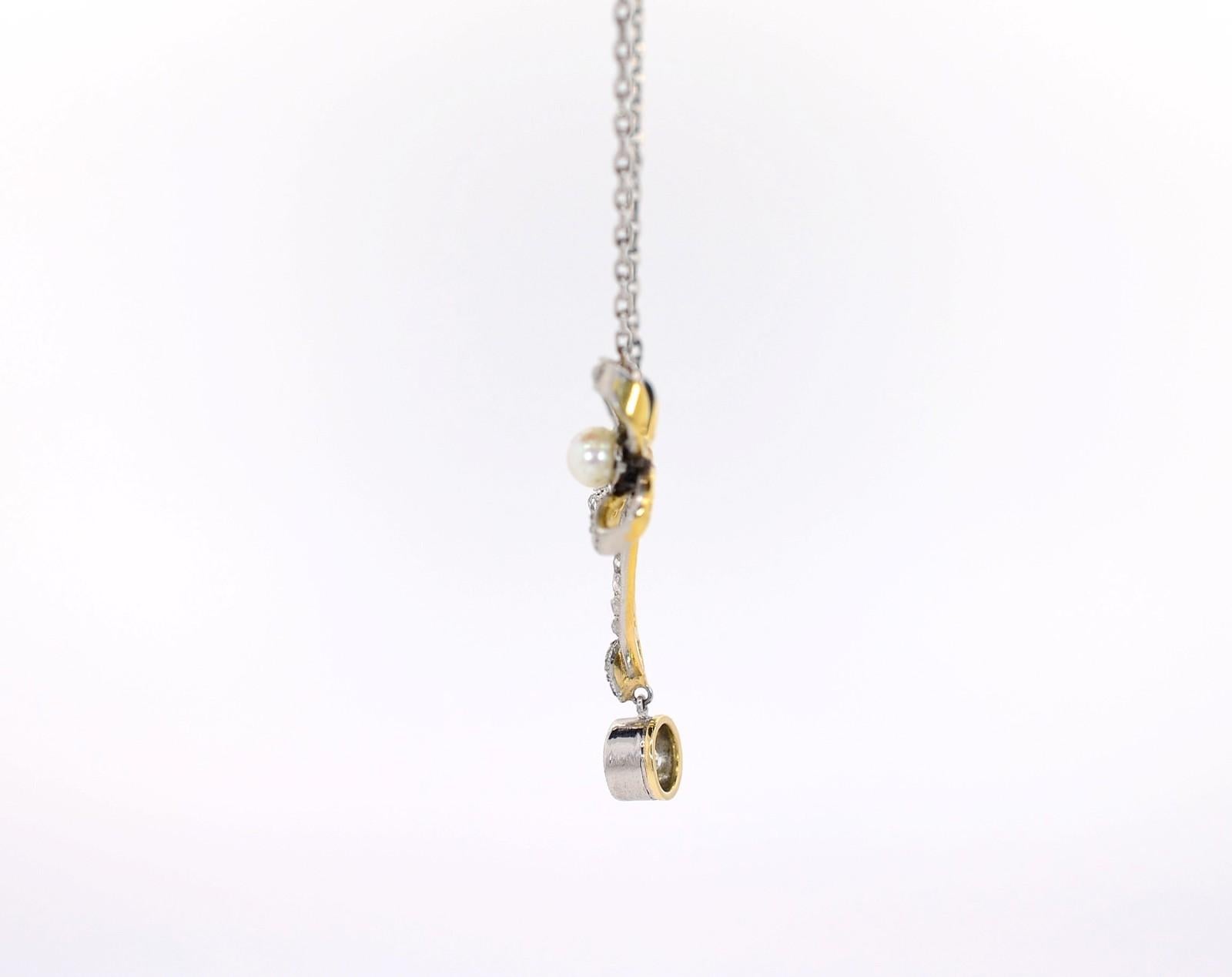 This delightful festoon style antique pendant dates back to the Victorian era 1890s.  Handcrafted of platinum topped 18KT yellow gold, it features bows adorned with two natural white Pearls and resplendent Rose cut Diamonds.  It dangles a sparkly