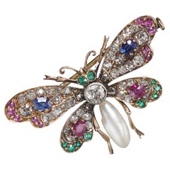 Broche papillon ancienne en argent et or avec diamant, perle, saphir, rubis et émeraude