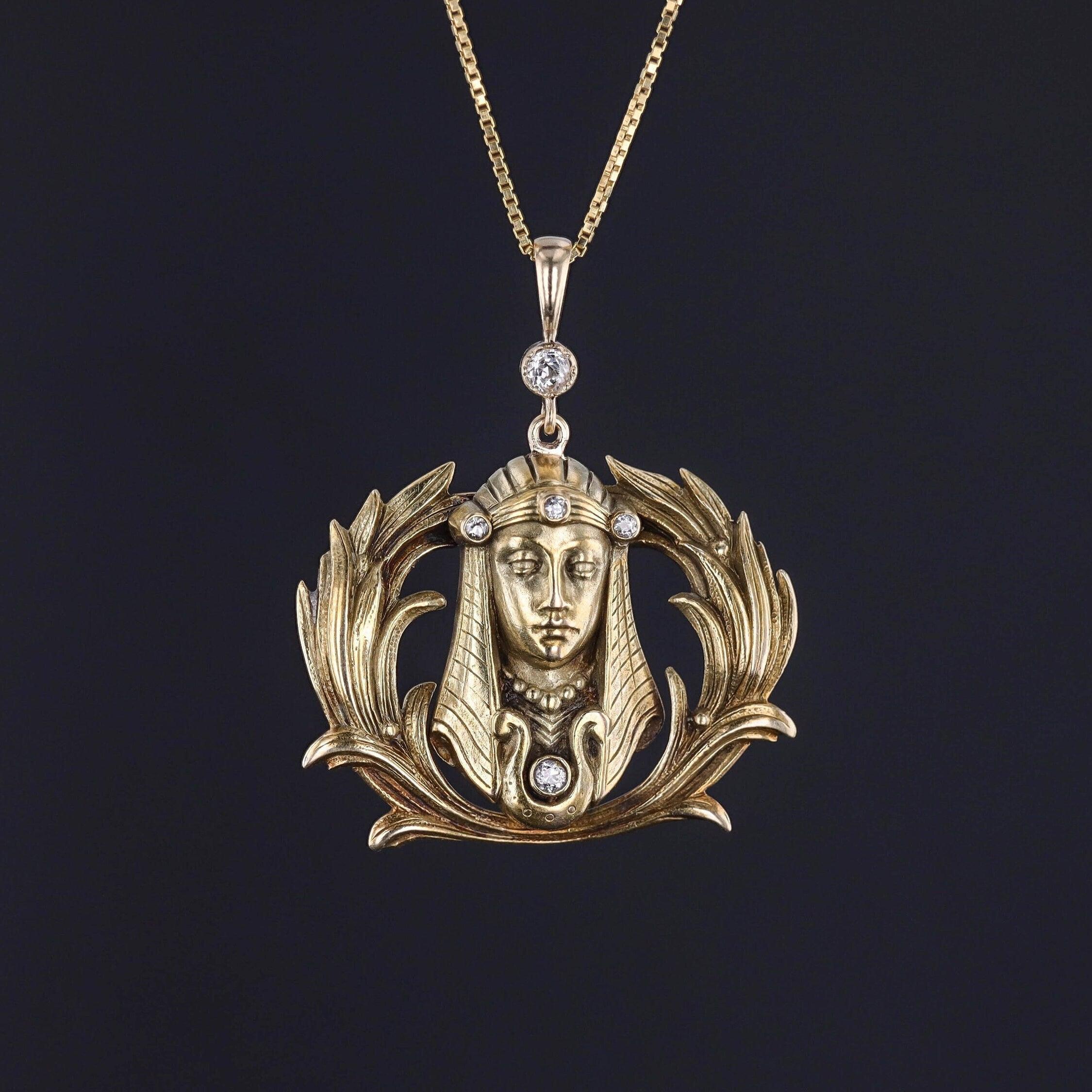 This 14k gold pendant features a pharaoh adorned with glittery diamond accents. The pendant was originally an antique brooch (circa 1910) that our jeweler transformed by removing the pin findings and adding a diamond surmount and 14k gold bail.

The