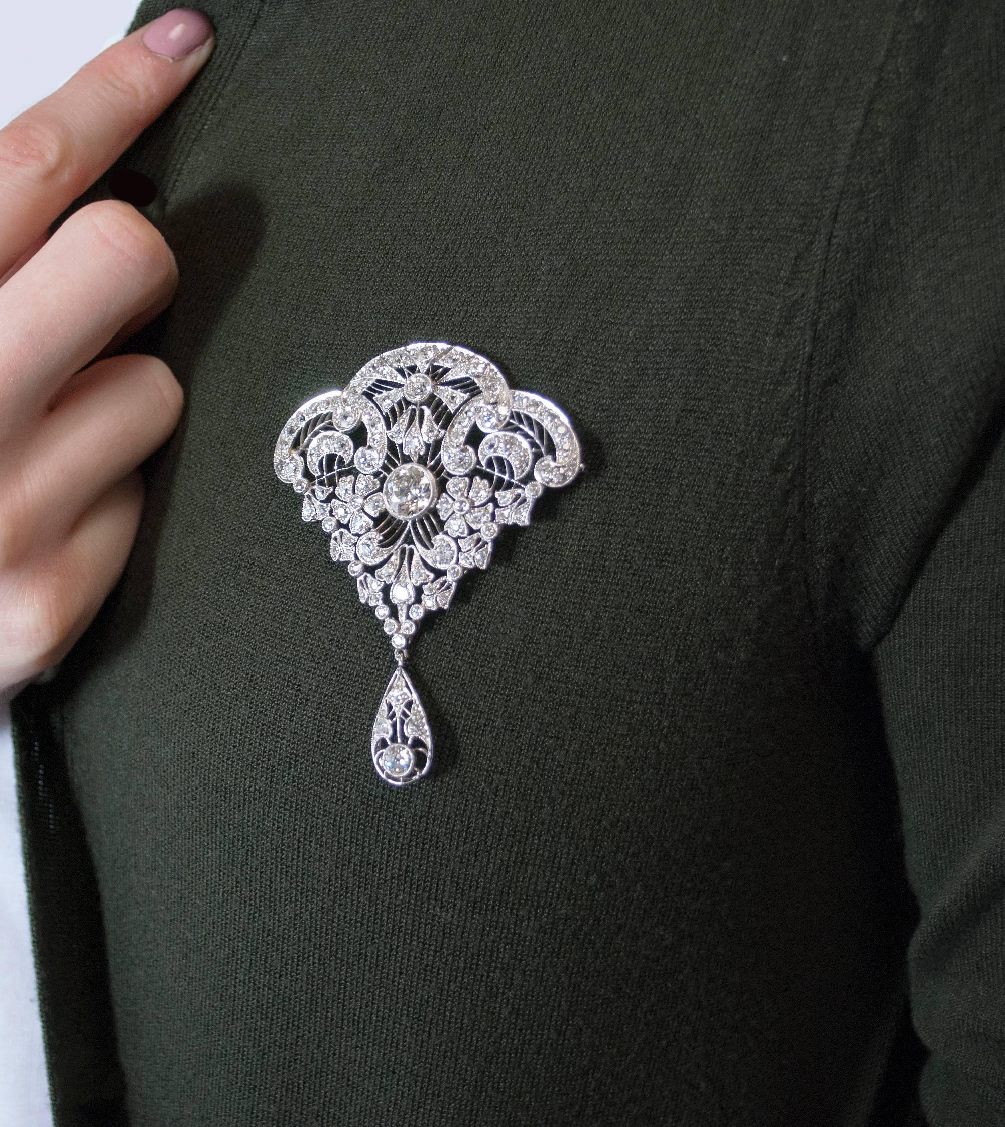 This gorgeous diamond art deco pin is a unique sight of beauty.
Feminine with its delicate floral details, eternally stylish thanks to its symmetrical lines and visually striking thanks to its central round diamond, this pin guarantees to become a