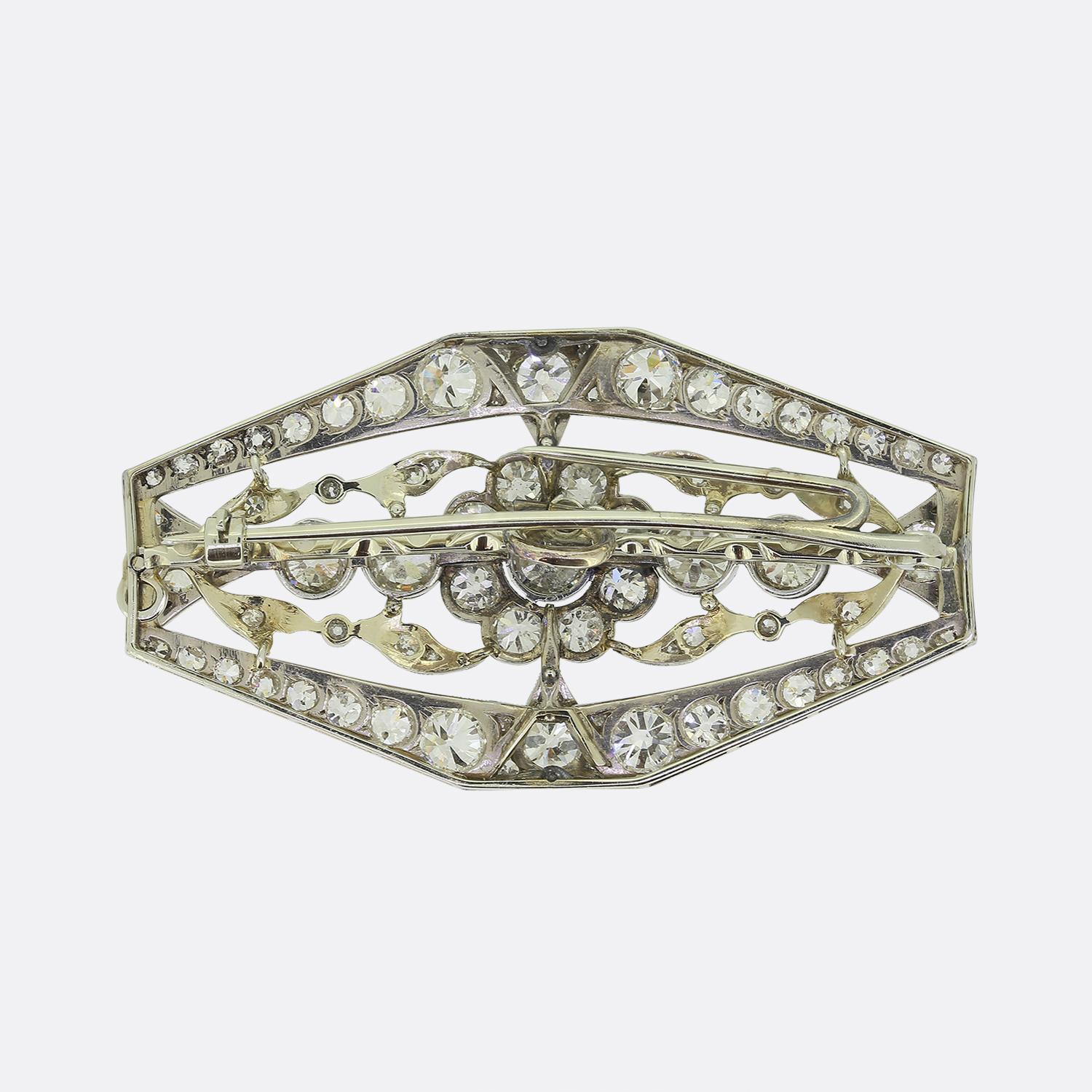 Here we have an outstanding diamond plaque brooch taken from turn of 19th century. This open multilayered piece has been crafted from 18ct white gold and plays host to a vast array of round faceted old mine cut diamonds set in a floral design amidst
