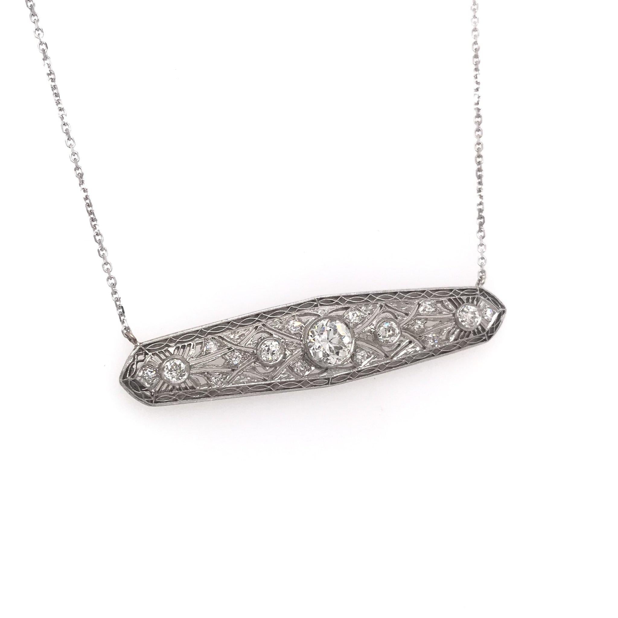 This piece is an antique revision made from reclaimed antique materials. This necklace was originally an antique platinum filigree brooch, handcrafted sometime during the Edwardian design period ( 1900-1920 ). The platinum pendant features a