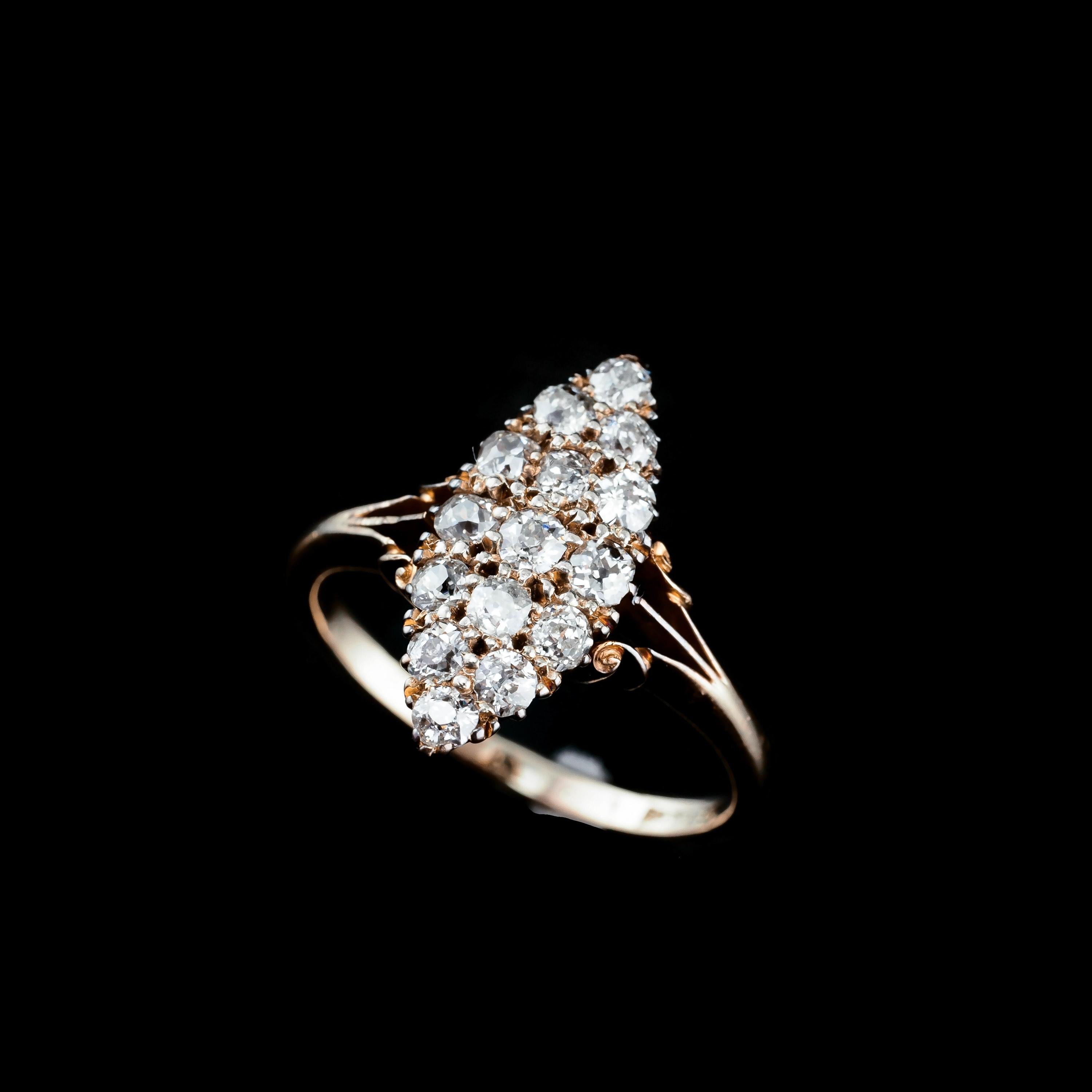 We are delighted to offer this splendid antique 18ct gold diamond ring made c.1900s. 
 
The ring features a wonderful 15 old-cut diamond design, all intricately set in a navette/marquise design. 
  
This design allows for the angles of the diamonds