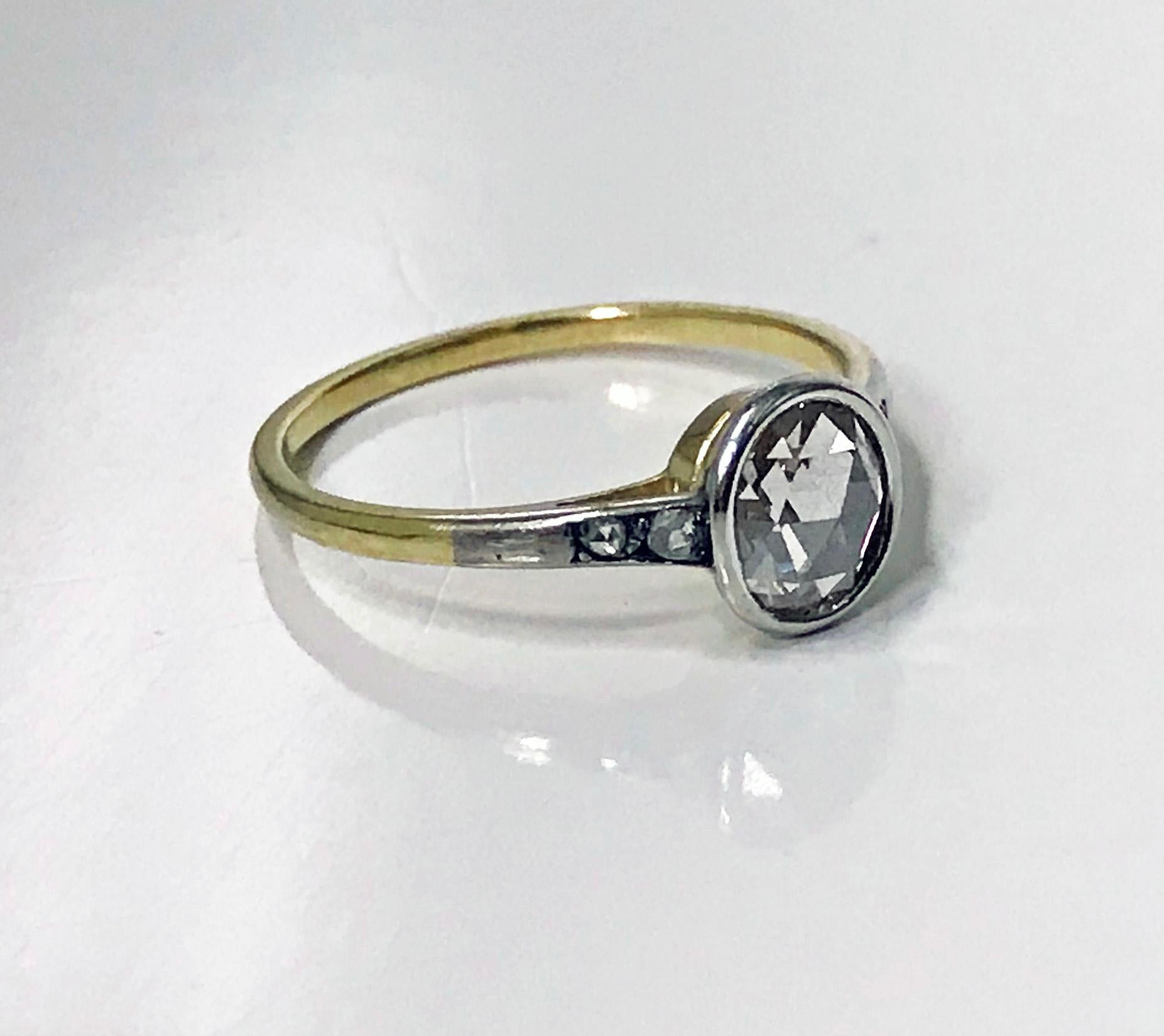 Antique Diamond Ring C.1920, Platinum and 14K Gold, acid tested . The Ring bezel set with an oval rose cut diamond gauging approximately 7.0 x 6.0 mm, approximately 0.55 ct, diamond weight, depth estimated due to closed back setting, approximately