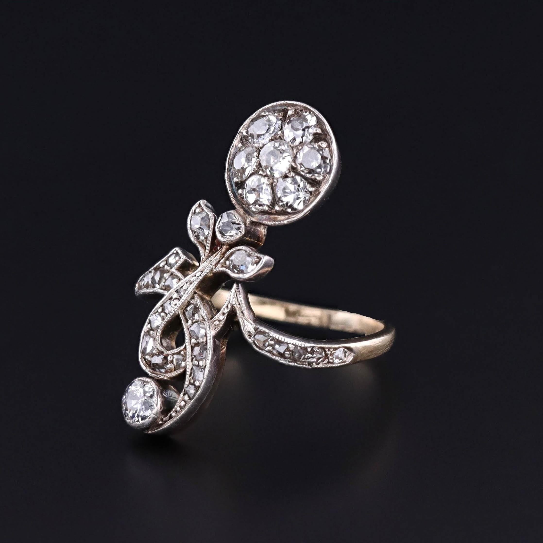Antique Diamond Ring: This antique ring (circa 1910) features a flower of old European cut diamonds and old mine cut diamonds, set in silver topped 14k gold. The diamonds have a total carat weight of 0.97ct.

The face of the ring measures 1.1 inches