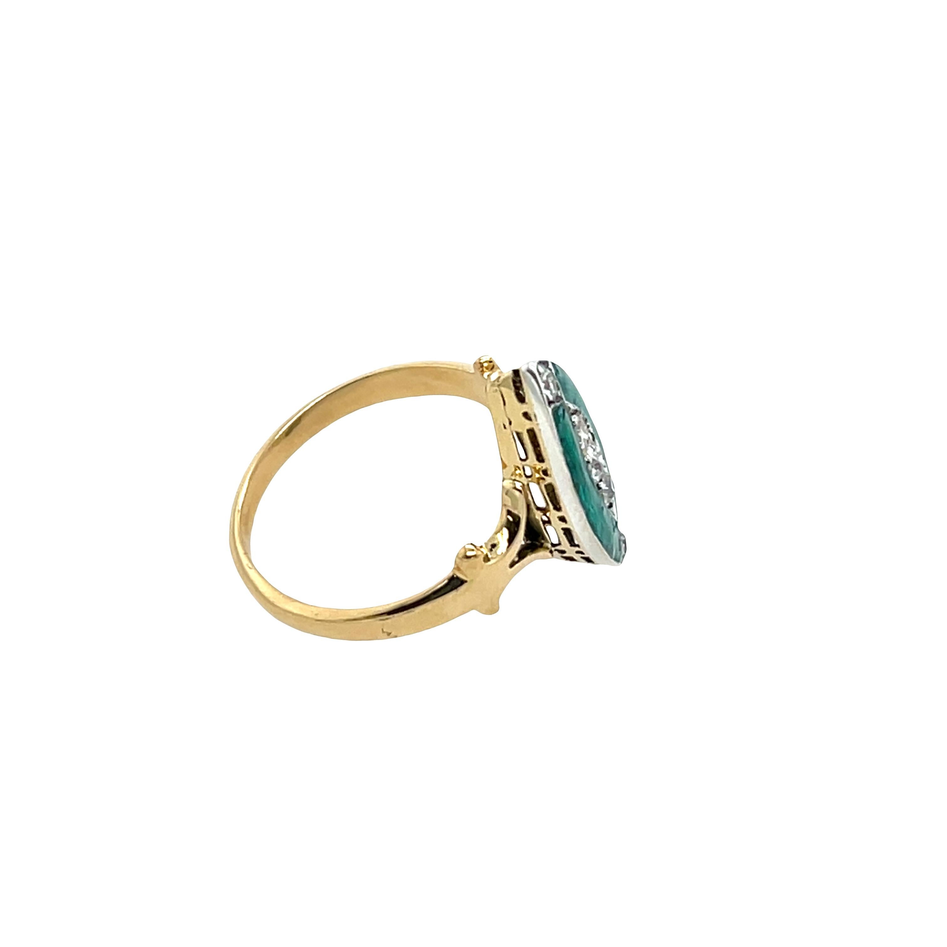 A striking antique marquise-shaped ring, beautifully crafted in 18ct yellow & white gold, featuring a delicate turquoise enamel and 5 sparkling rose cut natural diamonds centerpiece. The intricate marquise frame and rich enamel work reflect timeless