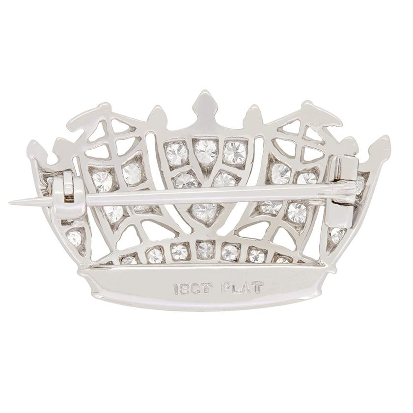 A beautiful piece of history, this Royal Navy crown brooch is grain set with 0.53 carat of diamonds. Crafted from platinum and 18 carat white gold, the design incorporates a ships sails and stern in an alternating pattern within the crown. The