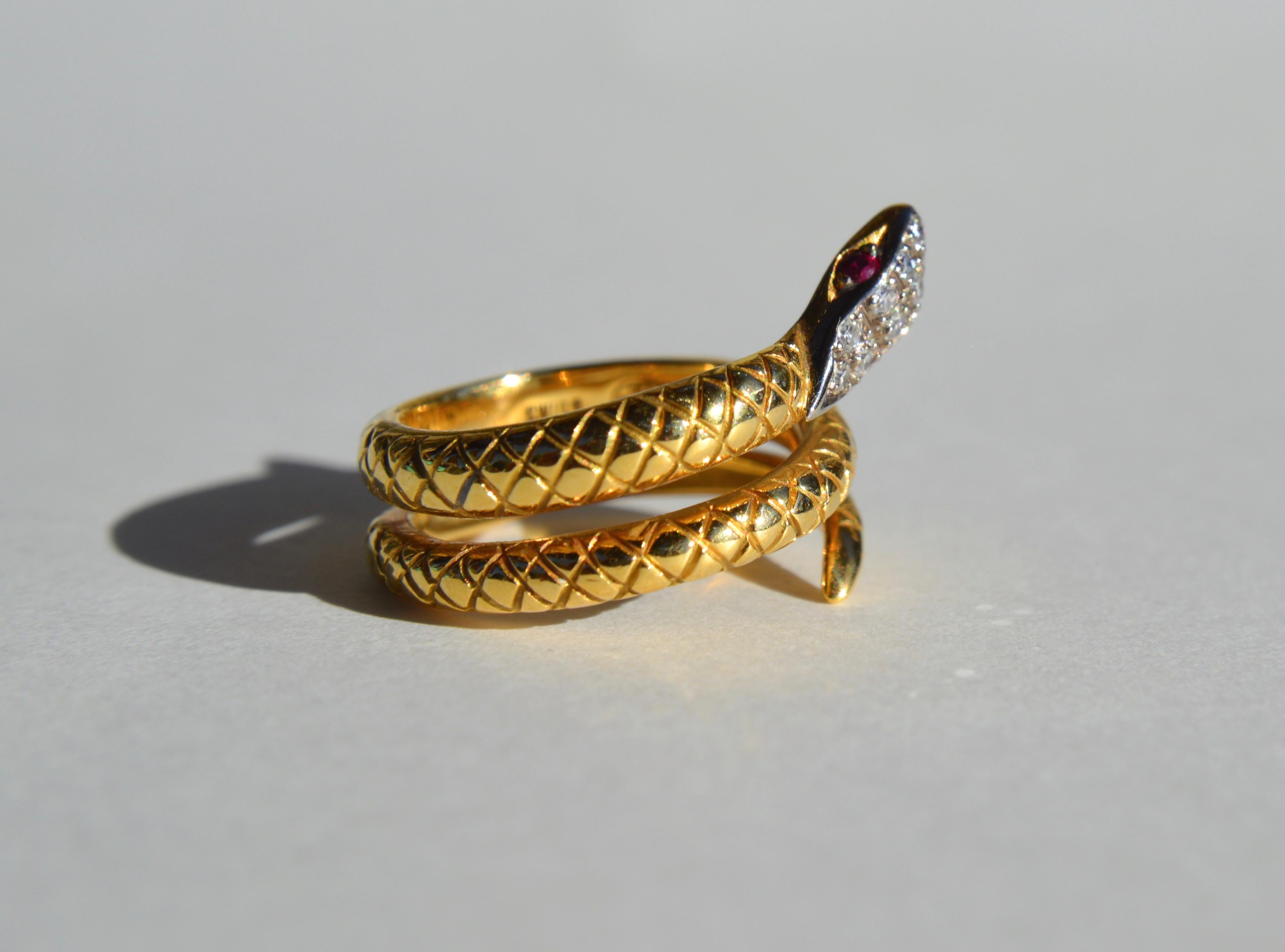 Beautiful Art Deco era circa 1920s - 1930s 18K yellow gold snake wrap ring with 8 round cut diamonds (each .015 carat, 1.5mm diameter) and round cut ruby eyes (each .015 carat, 1.5mm diameter). Size 4.5. Marked as 750 (18K gold) and stamped as