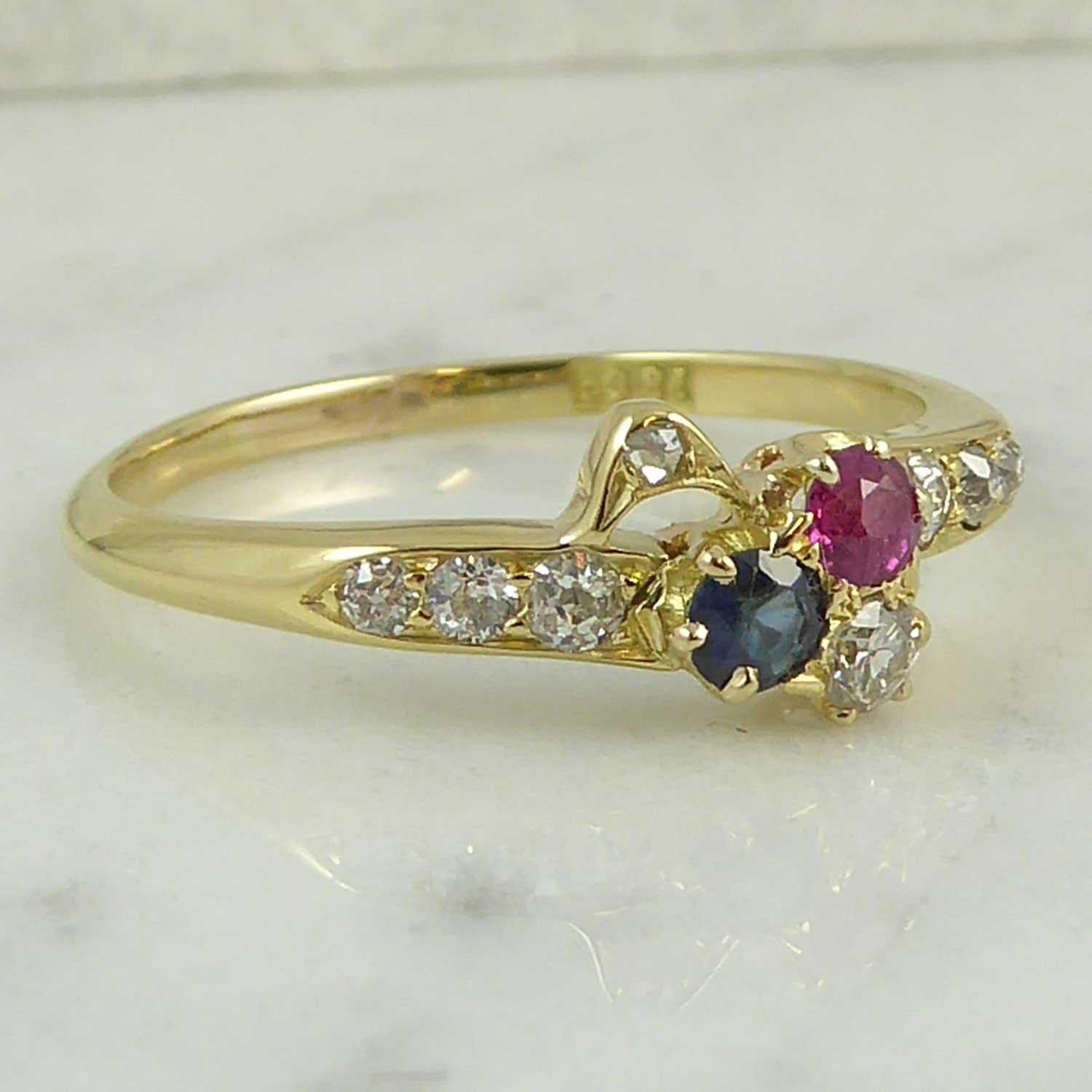This antique ring is such a sweet design.  Set with gemstone in the colours red, white and blue, this type of ring is often known as 
