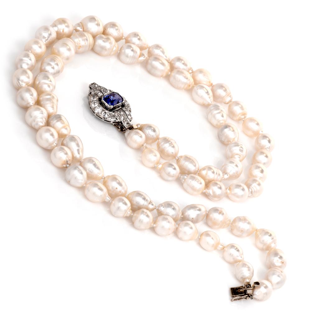This captivating antique pendant necklace is crafted incorporates two strands of lustrous white cream colored natural South Sea pearls ranging in size from 13mm to 9mm. Displaying a pendant crafted in solid platinum, set with a prominent AGL lab