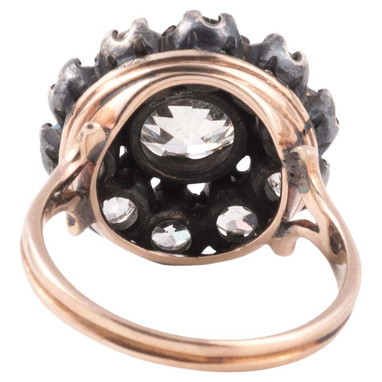 Centering on an old mine-cut diamond within a surround of old cut diamonds with floral motif, mounted in silver and gold, circa 1890
Size/Dimensions: US size 7
Diamond: Approximate total diamond weight of 2.50 carats
Gross Weight: 6.3 grams