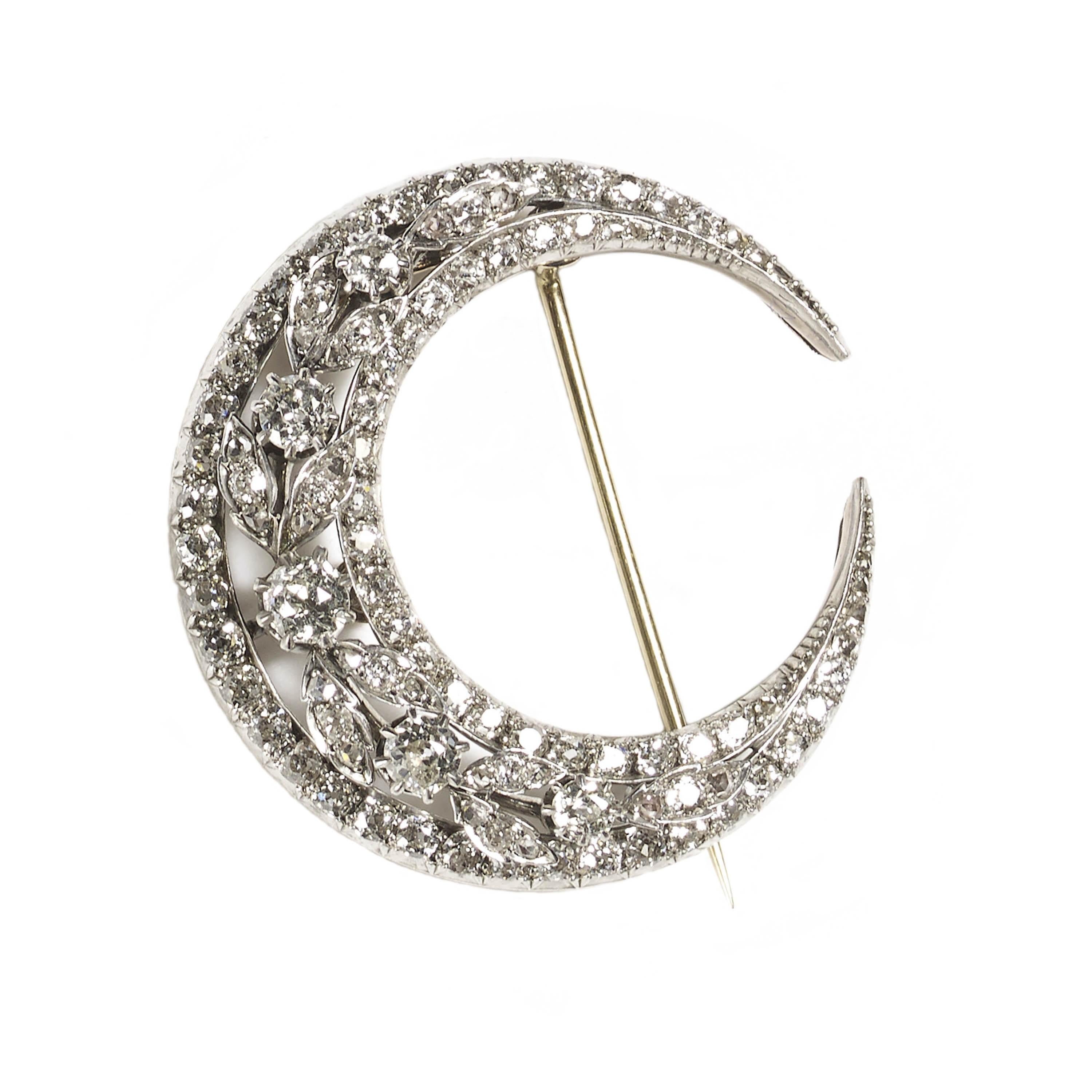 An antique diamond crescent brooch, set with old-cut diamonds, weighing an estimated total of 4.50ct, in a three row design, with an inner row and outer row, set with graduating old-cut diamonds, tapering to rose-cut diamonds, with a centre wreath