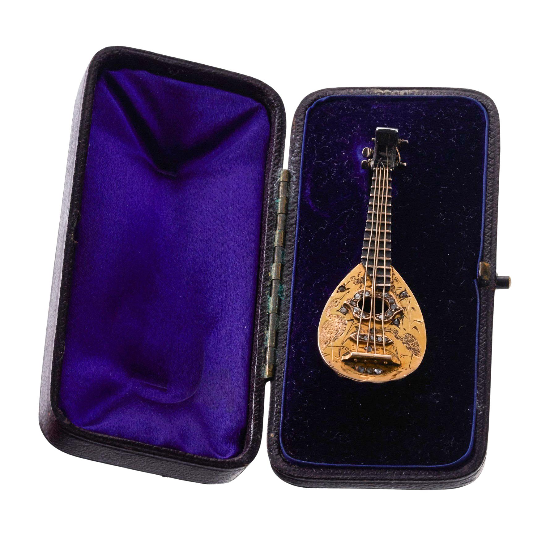 Antique 14k gold and silver mandolin brooch, adorned with rose cut diamonds. Brooch comes in original antique fitted box. Measures 60mm x 23mm. Tested 14k/Silver. Weight of the piece - 9.7 grams. 