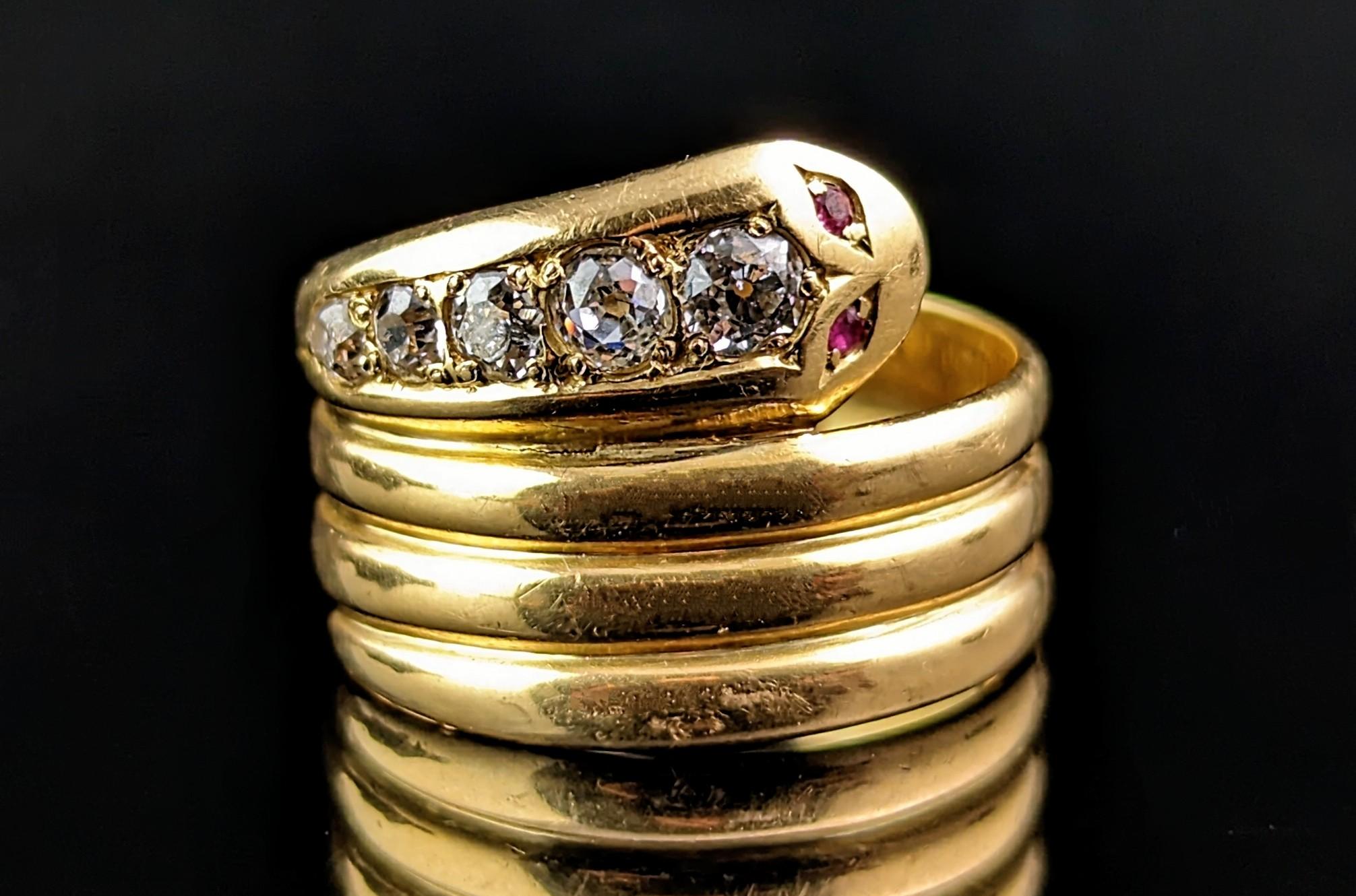 You can't help but be charmed by this impeccable antique, Art Deco diamond and Ruby snake ring.

Coils of rich, buttery yellow gold form the body of this fine fellow which curves around the finger effortlessly, the head resting at the top and loaded