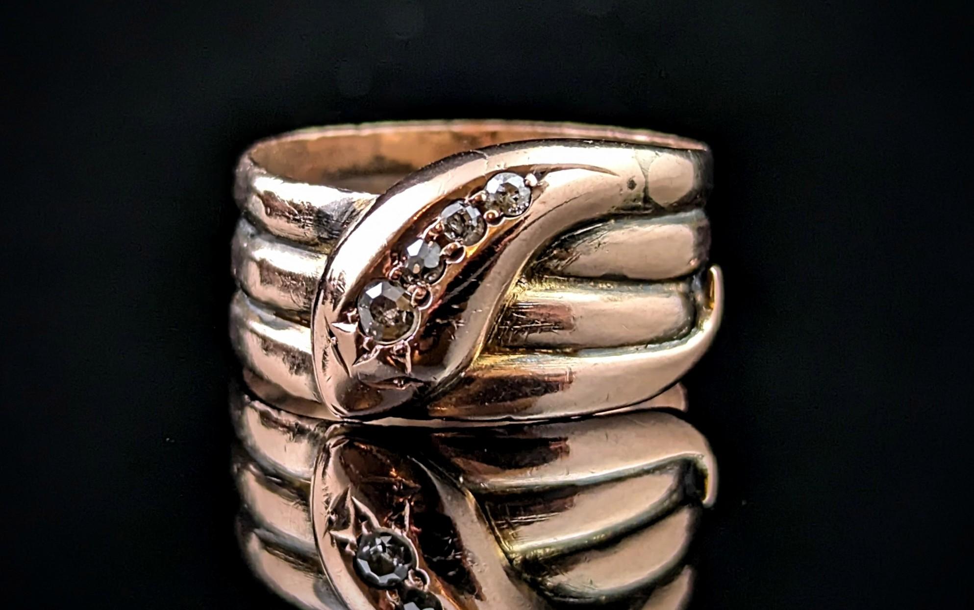 A handsome antique Diamond set snake ring.

Coils of rich rose gold form the body of the snake and the tail wraps all the way around.

Set to the head of are a selection of beautiful old cut diamonds with the most gorgeous twinkle Approx 0.20ct of