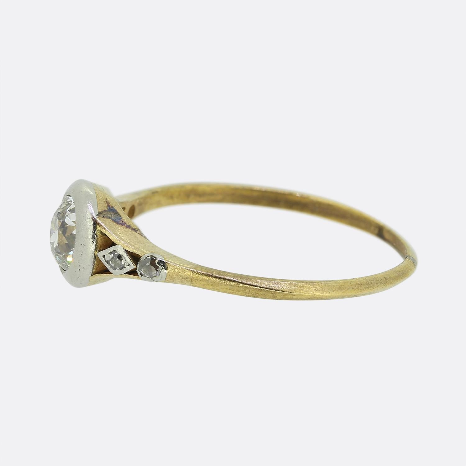 Here we have a beautifully crafted diamond solitaire ring which dates back to the Victorian period. A single round faceted old European cut diamond has been bezel set in platinum at the centre of the face amidst a pair of open split shoulders where