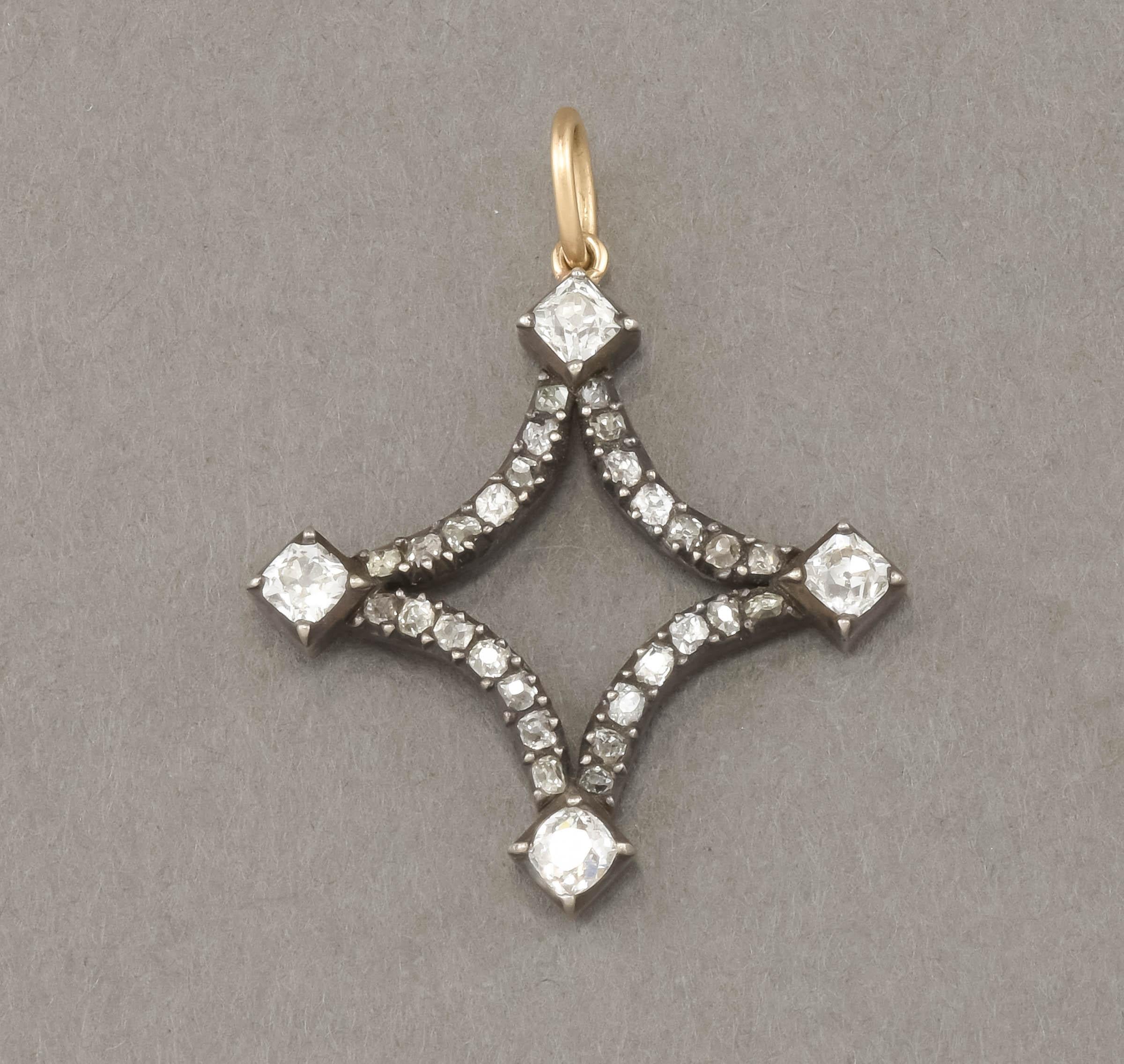 Offered is a striking antique diamond pendant in the shape of a stylized star.  Chunky & fiery old cushion cut diamonds dazzle in this piece that was converted from a larger antique Georgian era piece.  Estimated carat weight is approximately 2