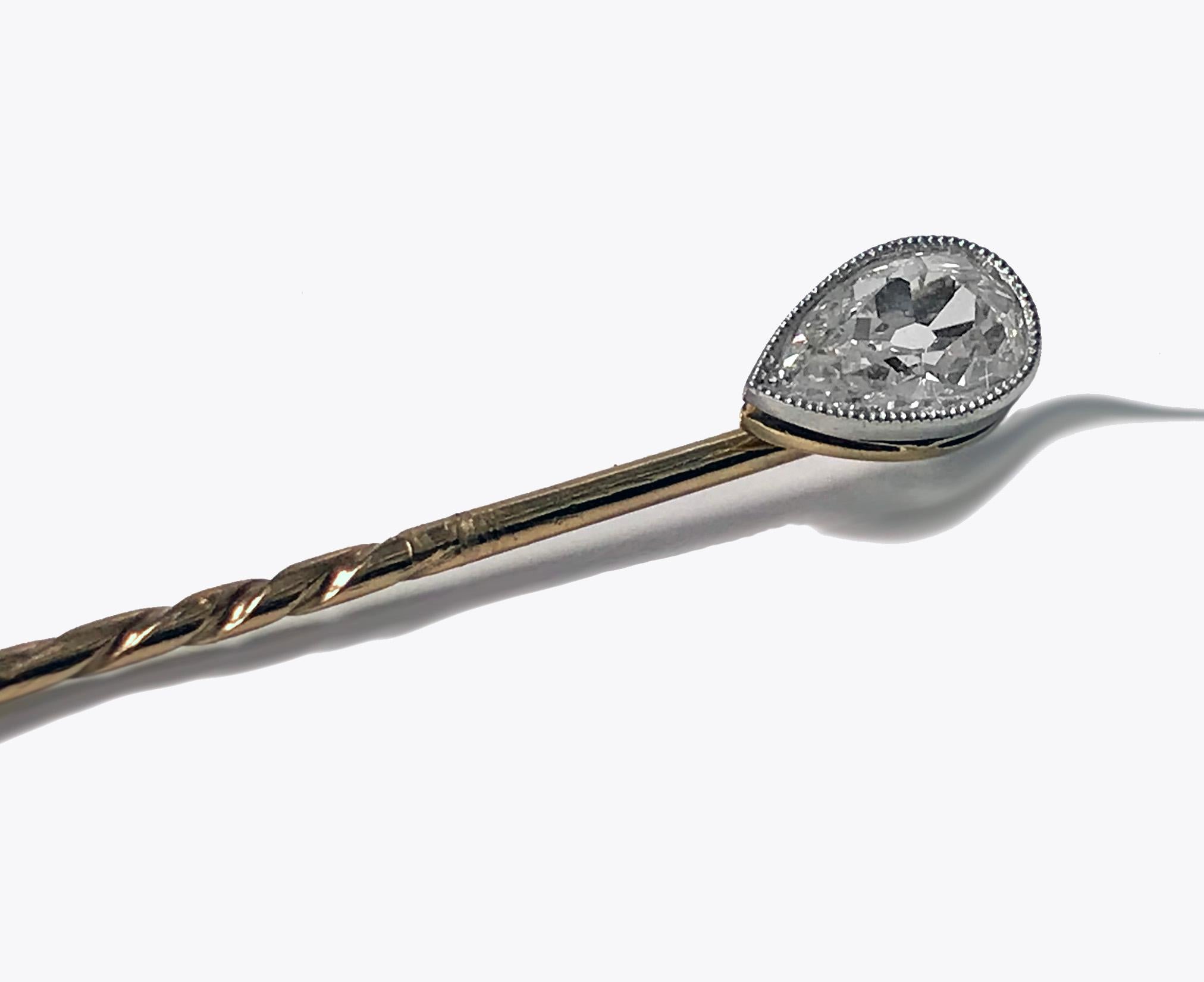 Antique diamond stickpin, circa 1910. The stickpin platinum milligrain set with an old pear cut diamond, approximately 0.50-carat, approximately SI clarity, approximately I-J color, split gallery mount, plain pin. Length: 2 inches. Total item