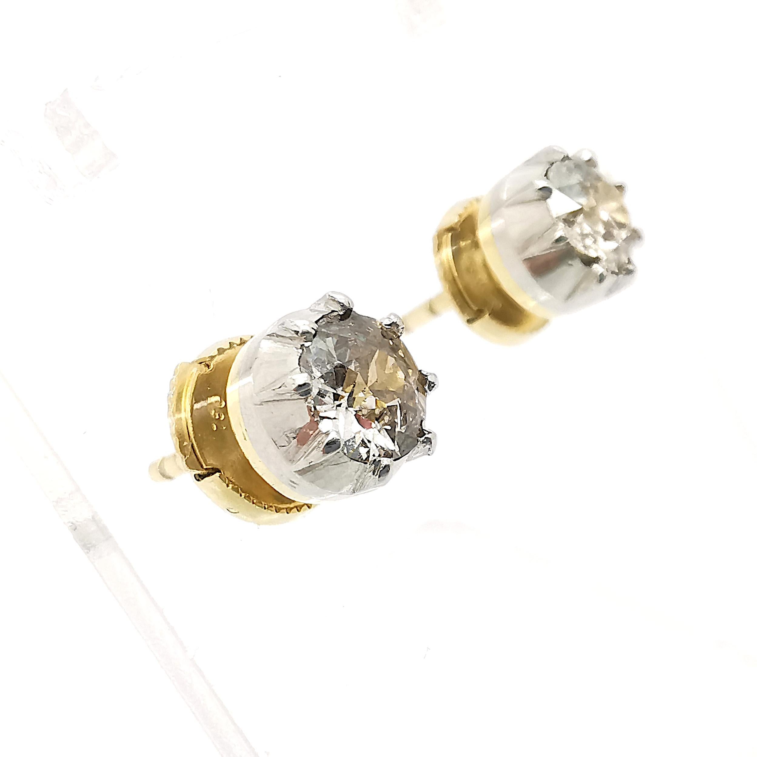 A pair of single stone diamond ear studs, with old cut diamonds in cut down settings, mounted in silver-upon-gold, with post and alpha clip fittings. Estimated total diamond weight 1.00ct.