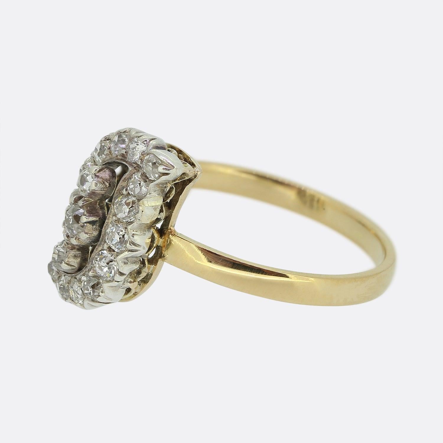 Here we have a fabulous diamond ring originally dating back to Victorian period. Three collet-set old cut diamonds sit proud at the centre of an open face. This trio is surrounded by a swirling motif adorned with a single row of matching old cut