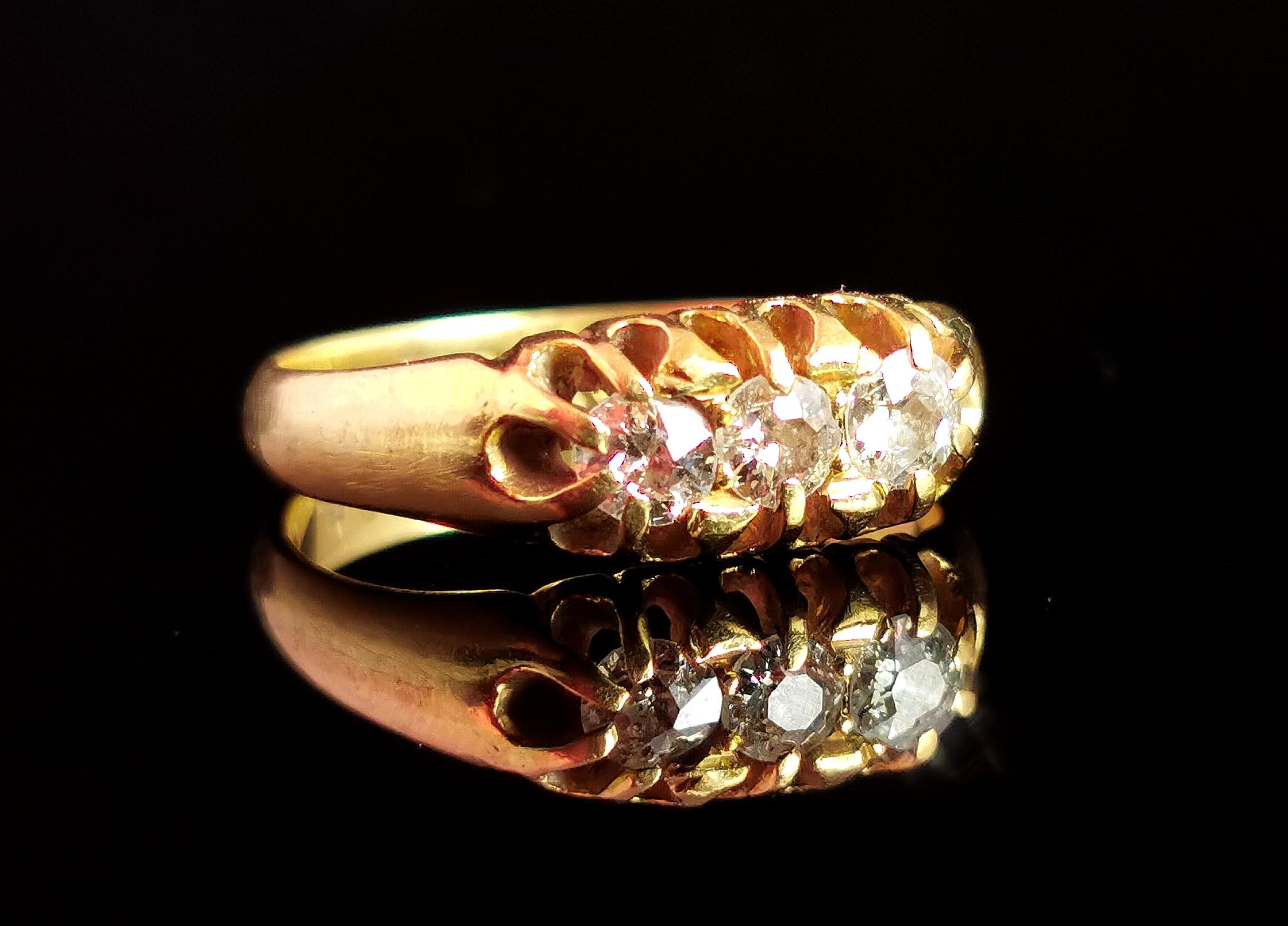 A gorgeous antique 18kt gold and diamond three stone ring.

Smooth and rich 18kt yellow gold band with tapering shoulders and a nice chunky band, it is a boat head ring with the stones claw set to the face, the type of rich golden hue found only on