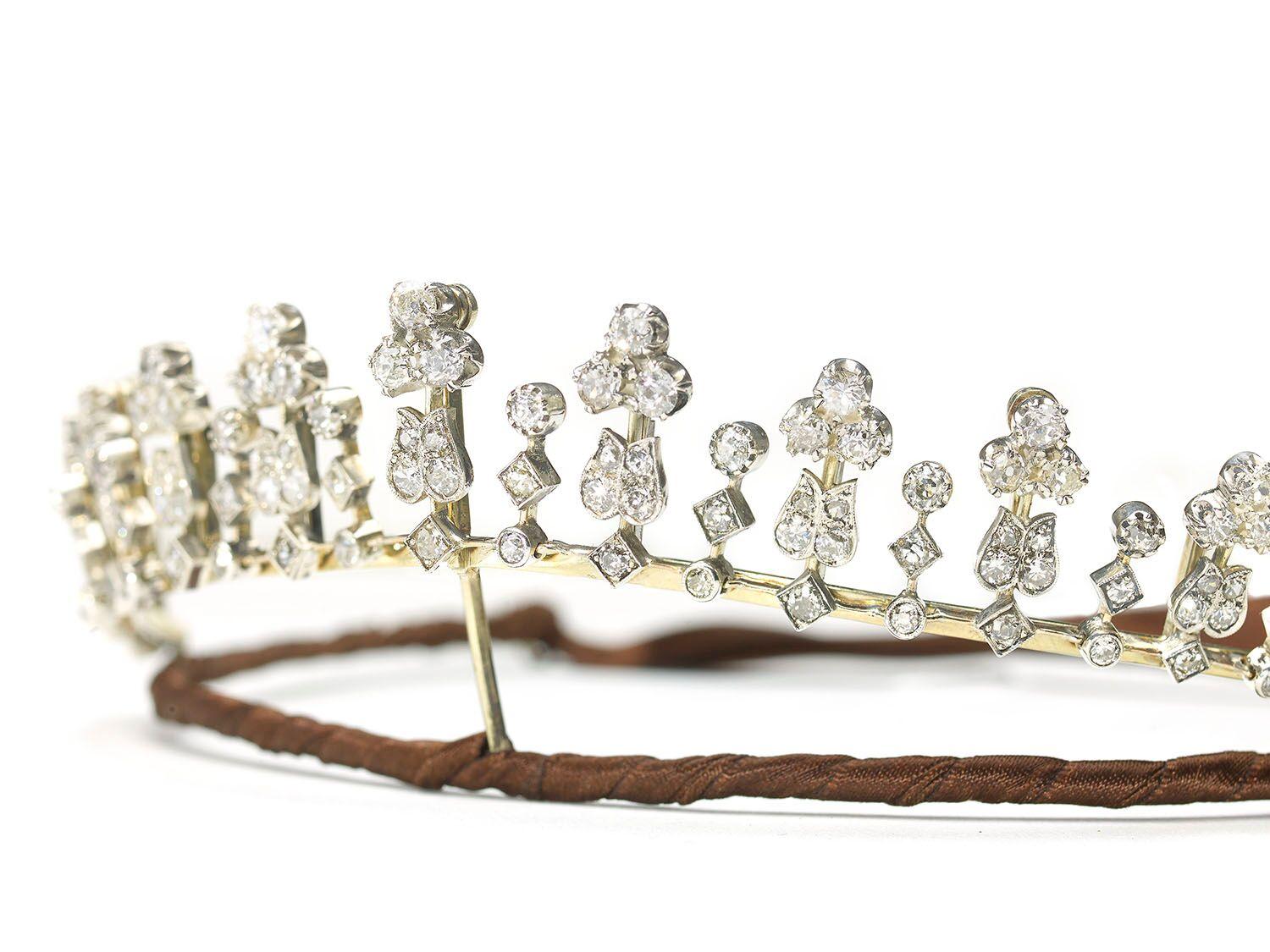 An antique diamond tiara, which can be worn as a necklace. It is set with approximately 20.00ct of old-cut diamonds. The front section is a graduating series of alternating old-cut diamond set trefoils, surmounting tulips, and three stone diamond