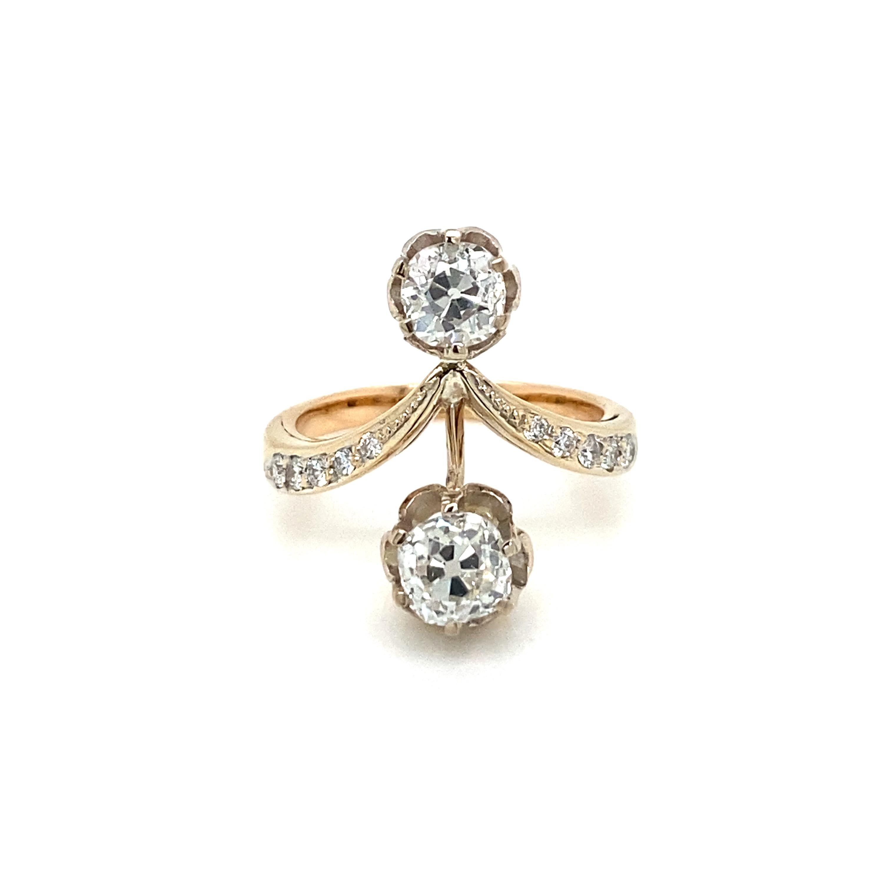 This Beautiful Authentic 18k gold 'Vous et Moi' ring is set with two large Sparkling Old mine cut diamonds, the largest weighs 1.10 ct., graded G/H color Vs1, the smallest weighs  0.50 ct., graded G/H color Vs1, The mount is enriched by old cut