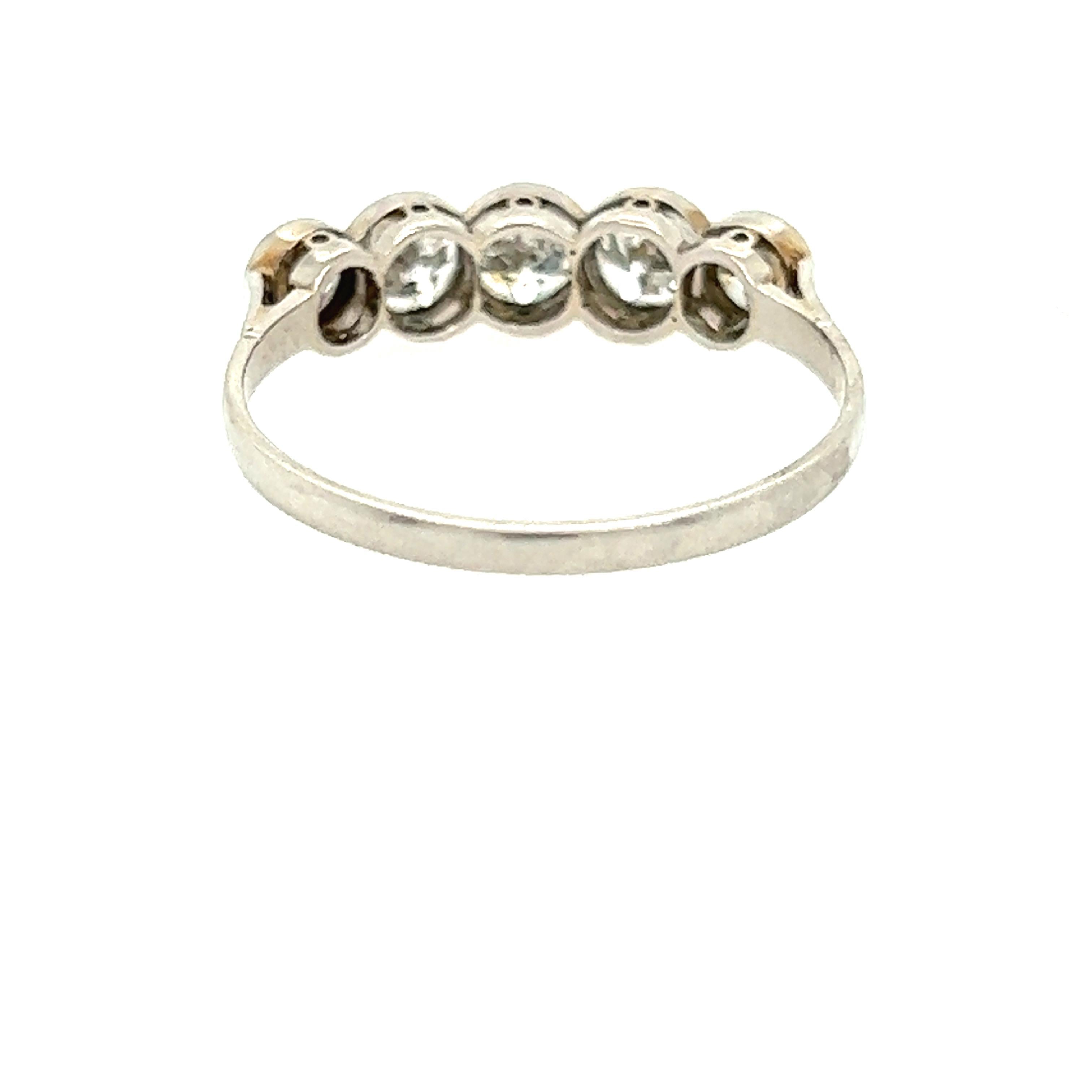 This exquisite antique diamond wedding band from the 1940s is a treasure from the Art Deco era. Crafted from lustrous platinum, this stunning ring features five sparkling diamonds across the top that weigh a total of 1.00 carats. This unique piece