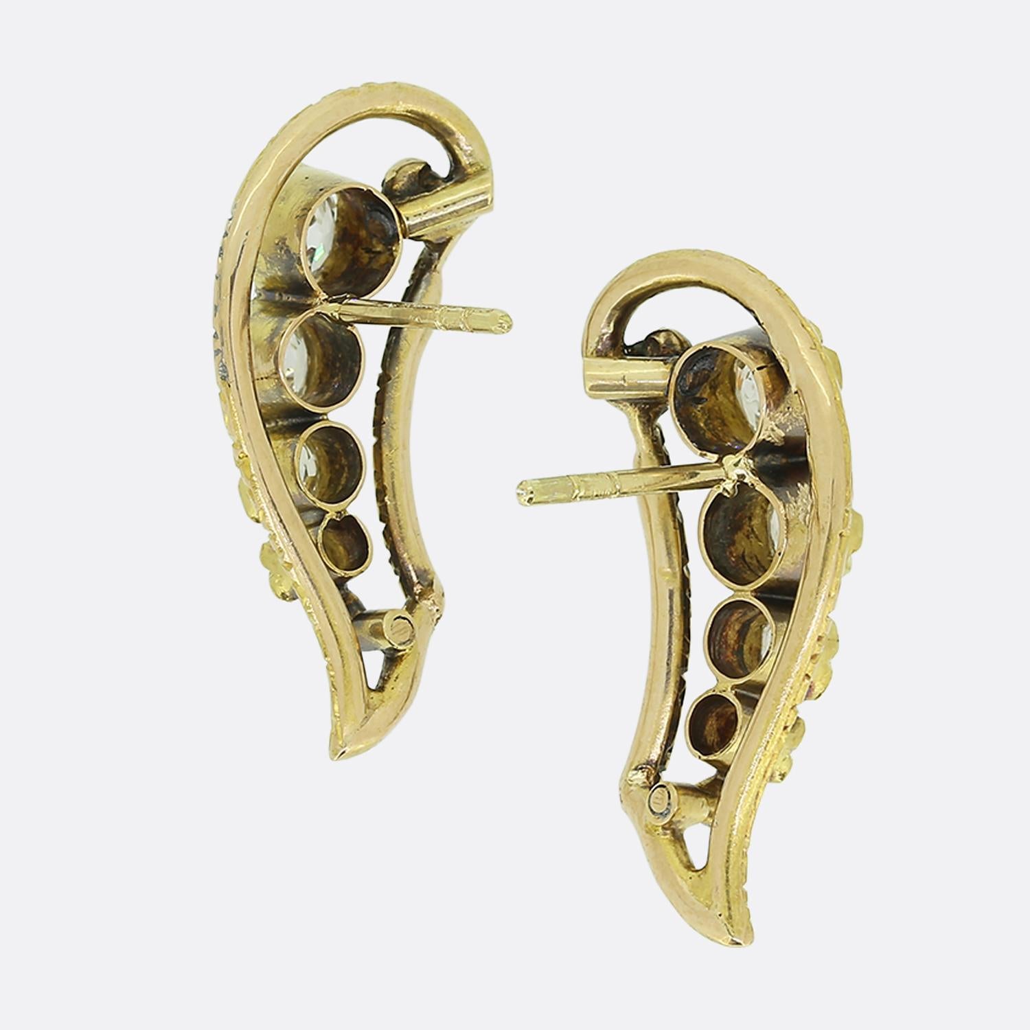 Here we have a wonderful pair of antique diamond earrings. They are crafted in 18ct yellow gold and each earring plays host to five old cut diamonds which graduate in size with the largest at the top. The central section is bordered in gold with a