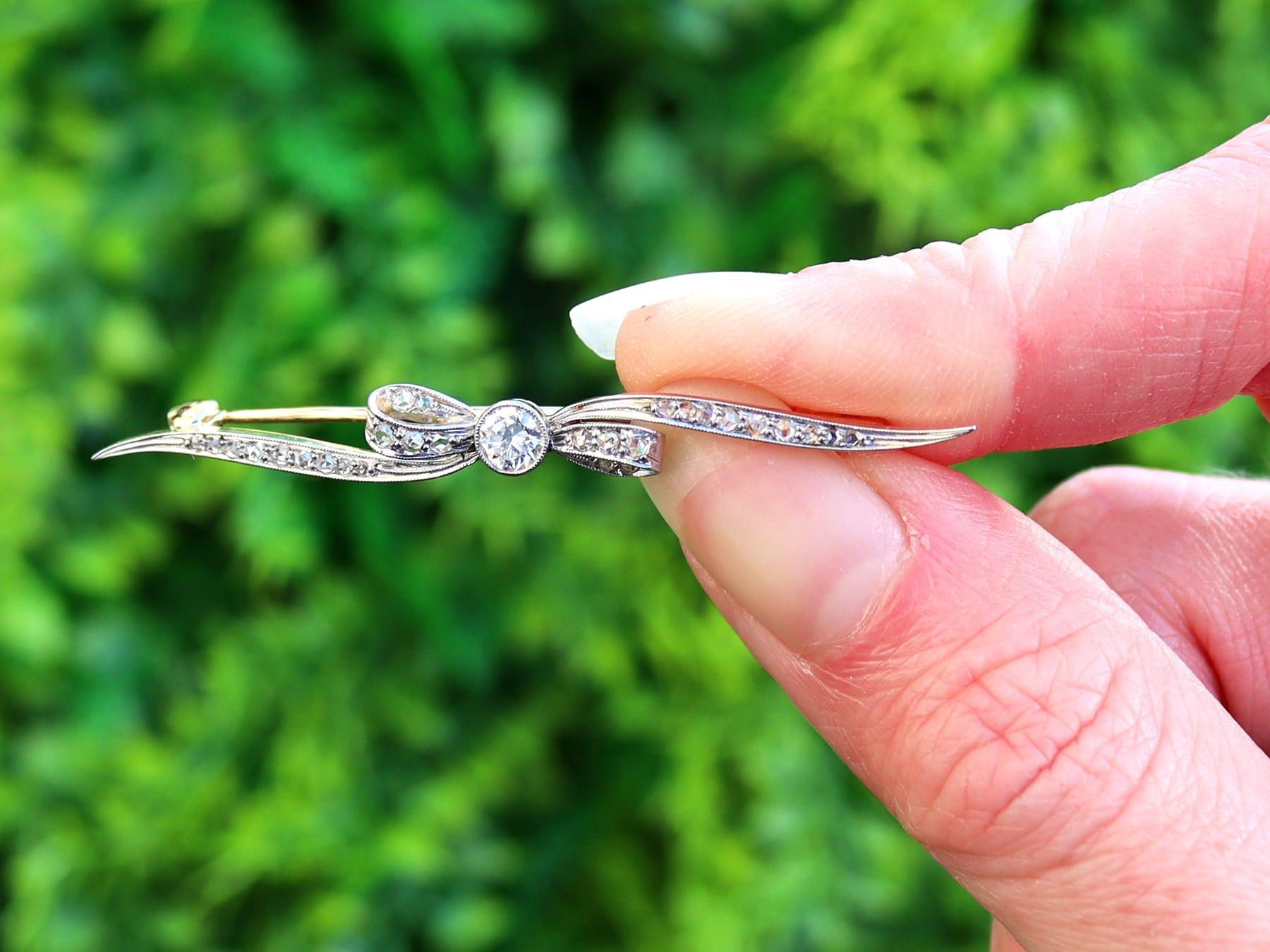 An impressive 0.68 carat diamond and 14 carat yellow gold, 14 karat white gold set bar brooch in the form of a bow; part of our diverse antique jewelry collections.

This fine and impressive antique bow brooch has been crafted in 14k yellow gold