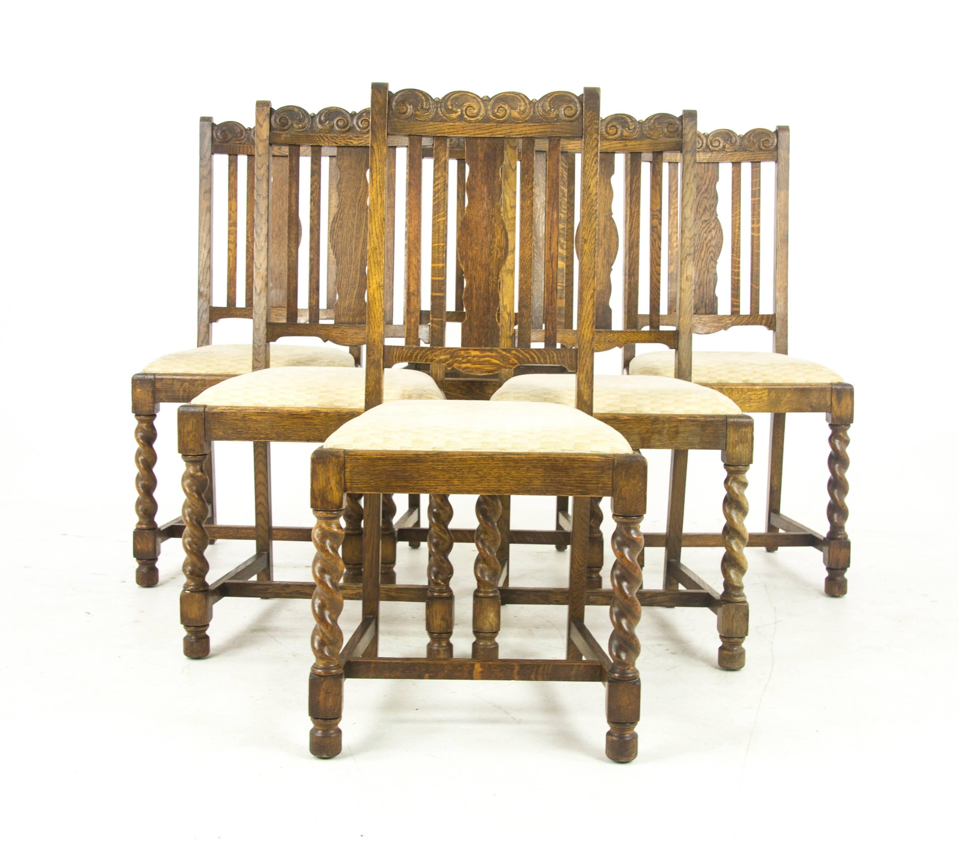 Antique dining chairs six, barley twist oak, Scotland, 1920, Antique Furniture, B1052.

Scotland, 1920.
Solid oak construction
Original finish
Carved top rail
Vertical slats
Upholstered lift out seats (1 missing seat)
Supported by thick